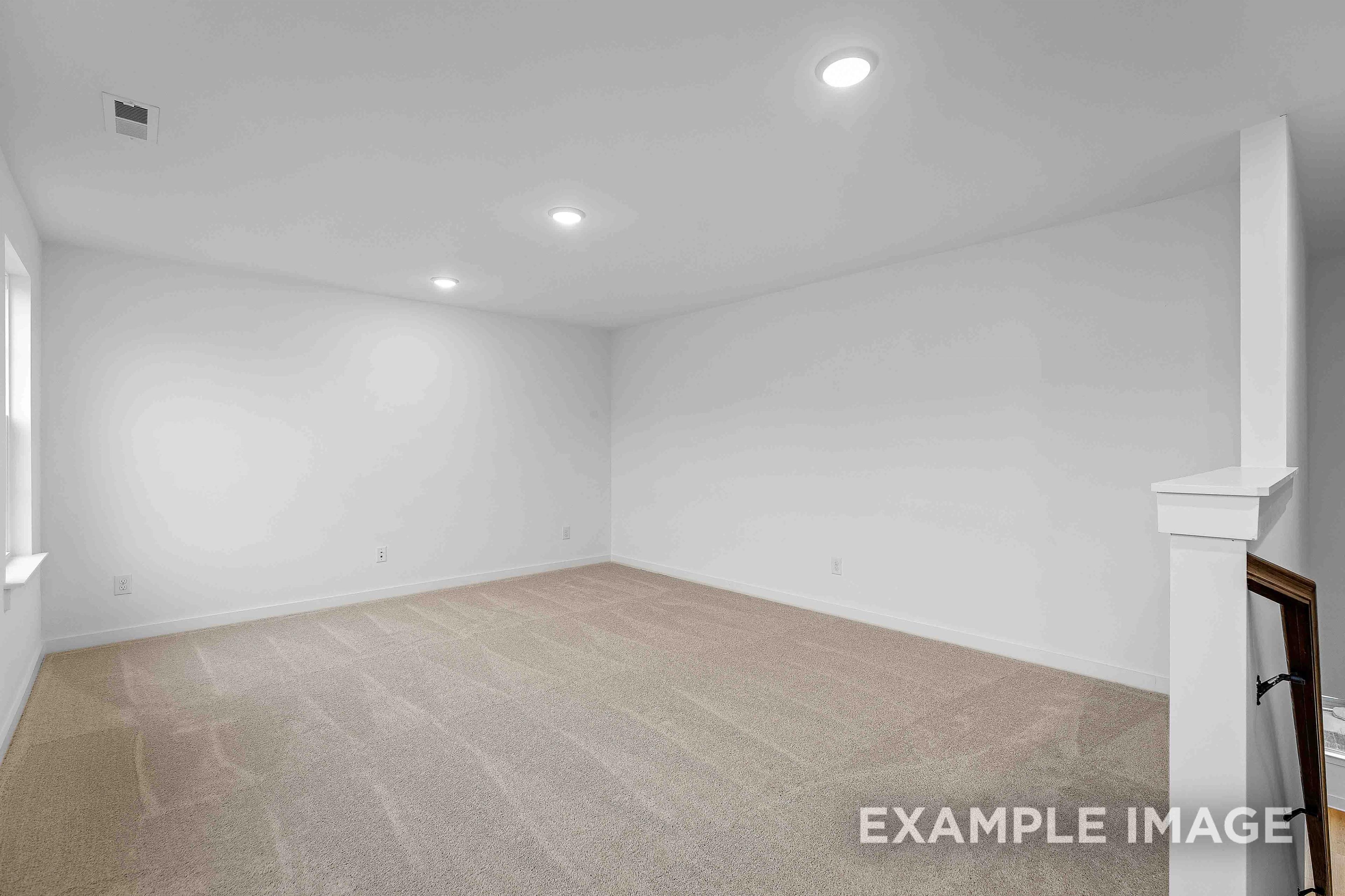 Spacious empty upstairs bedroom in The Charleston C with white walls, beige carpet flooring, recessed lights, and window sill