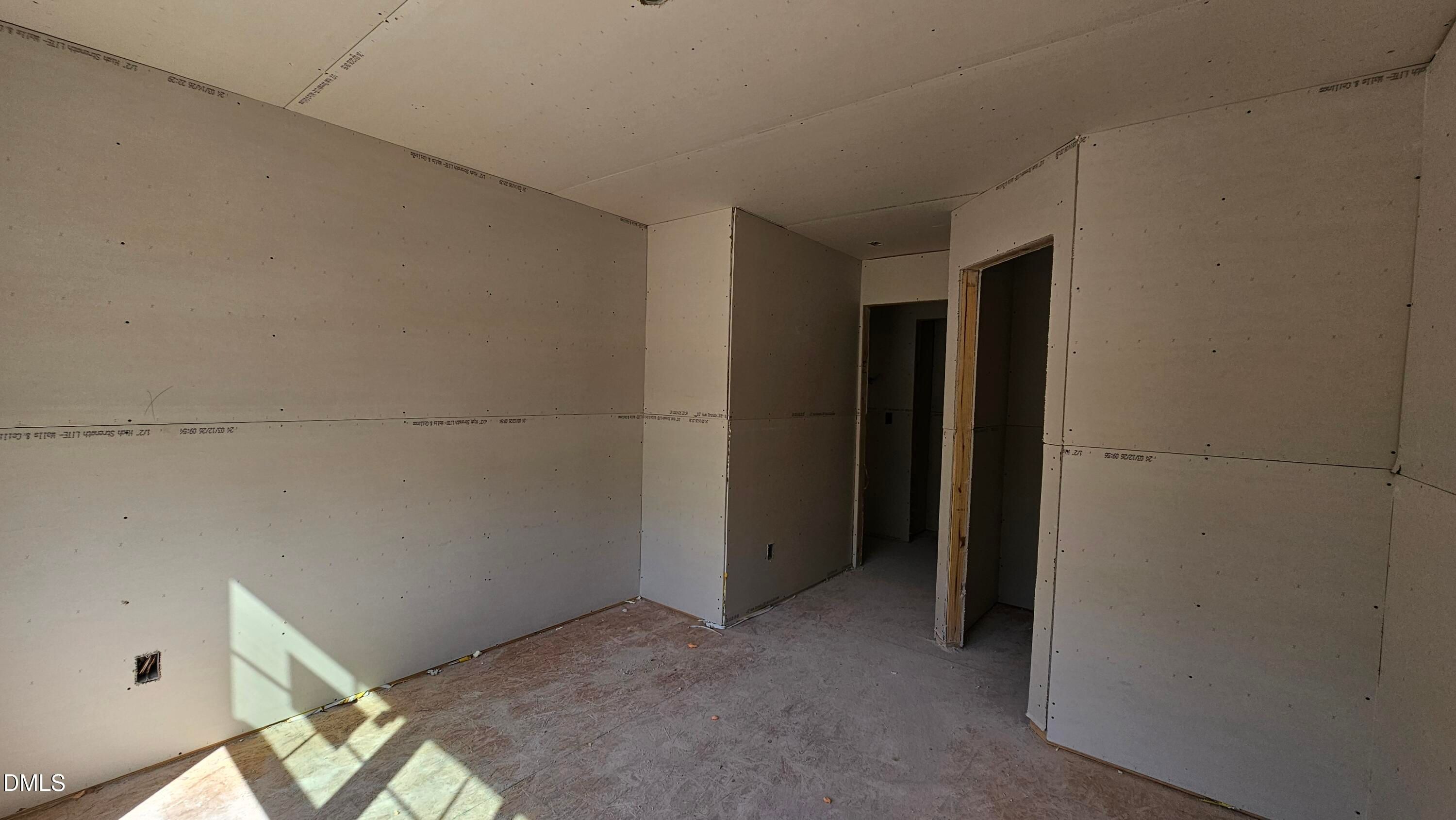 Unfinished bedroom interior with drywall installation in The Graham floor plan at Springvale, Fuquay-Varina, NC.