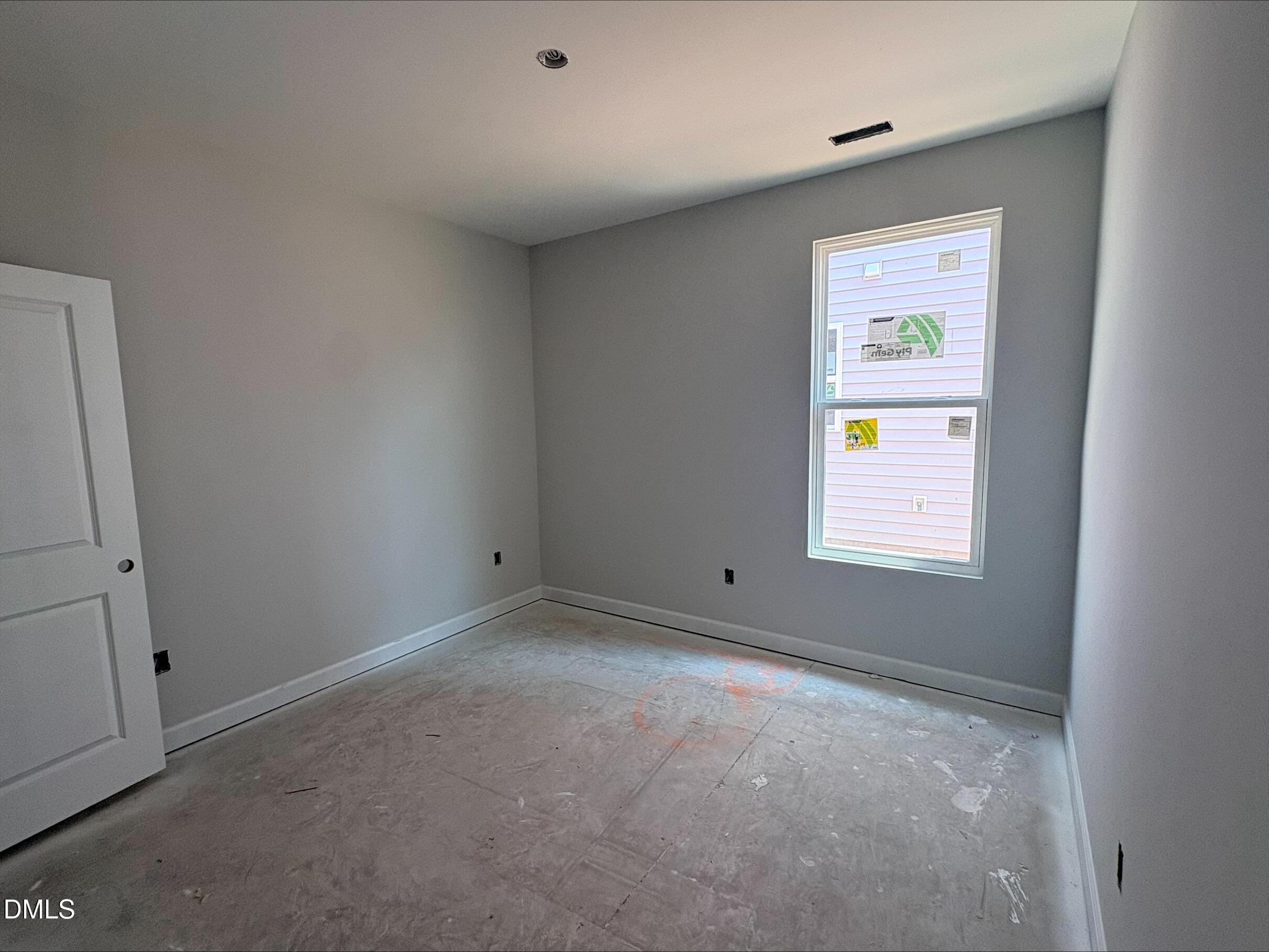 Unfinished bedroom with grey walls and white trim in The Daphne D floor plan at Woodland Crossing in Zebulon, NC.