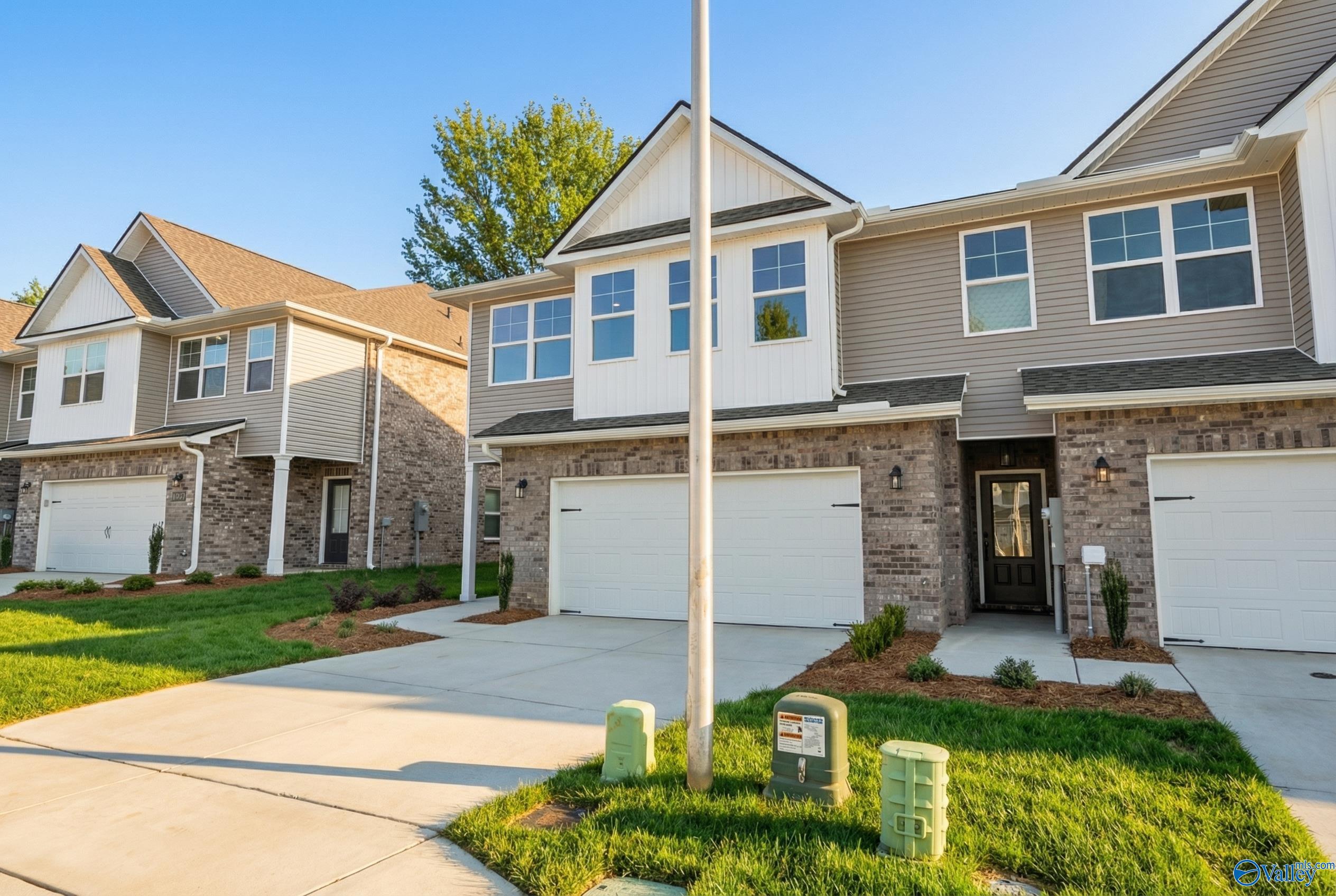 Modern two-story Camden home by Davidson Homes featuring two-car garage, brick accents, and lush front yard in Pavilion, Huntsville, Alabama