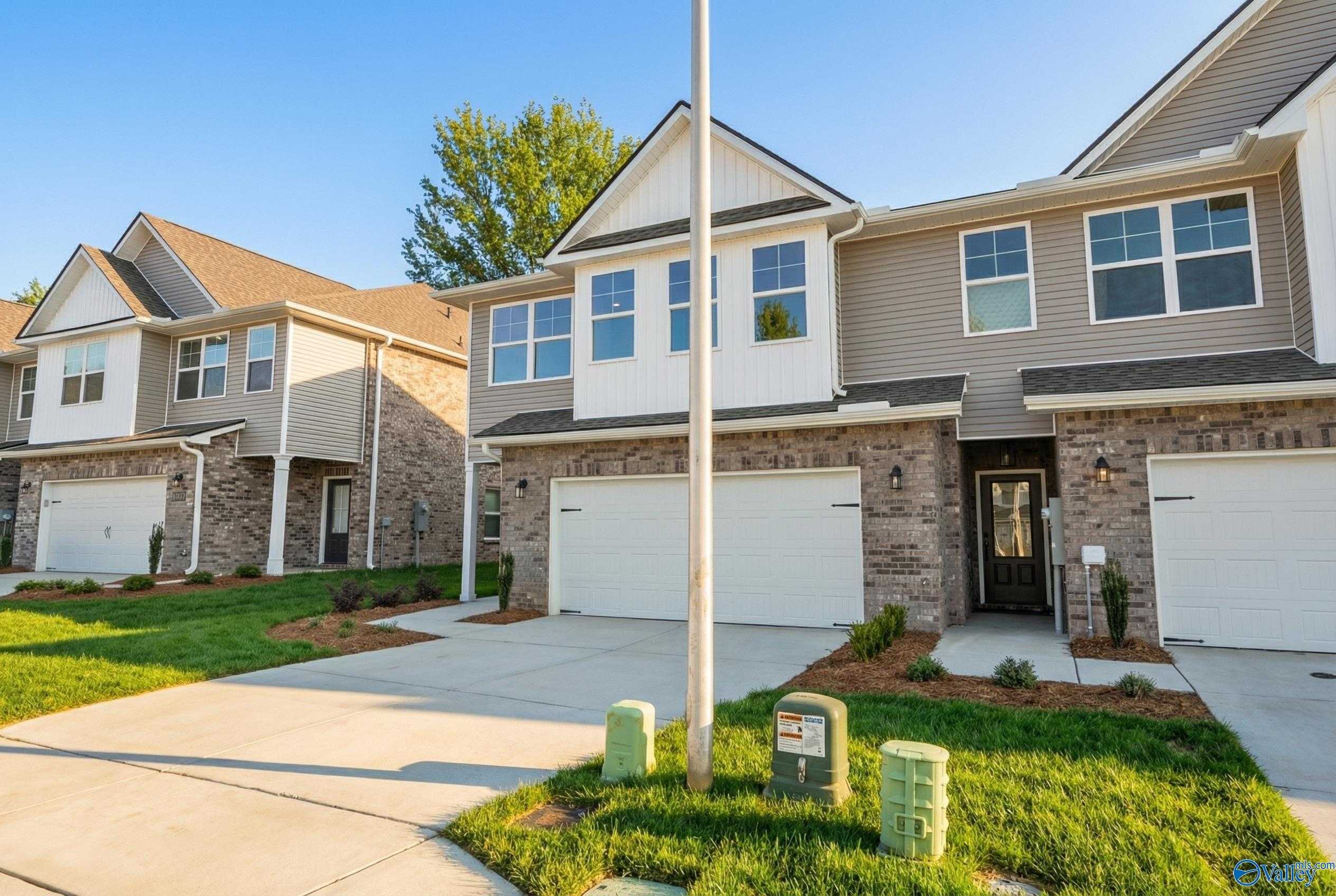 Modern two-story Camden home by Davidson Homes featuring two-car garage, brick accents, and lush front yard in Pavilion, Huntsville, Alabama