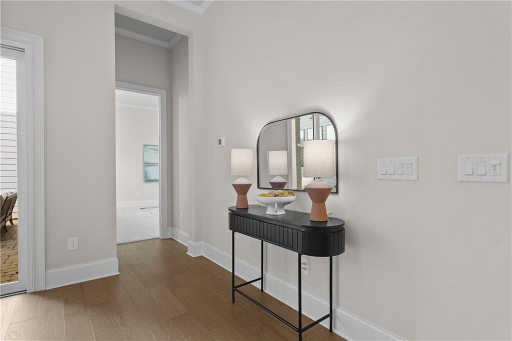 Elegant entry foyer with black console table, arched mirror, terracotta lamps in Davidson Homes The Seaside B, Woodstock, GA