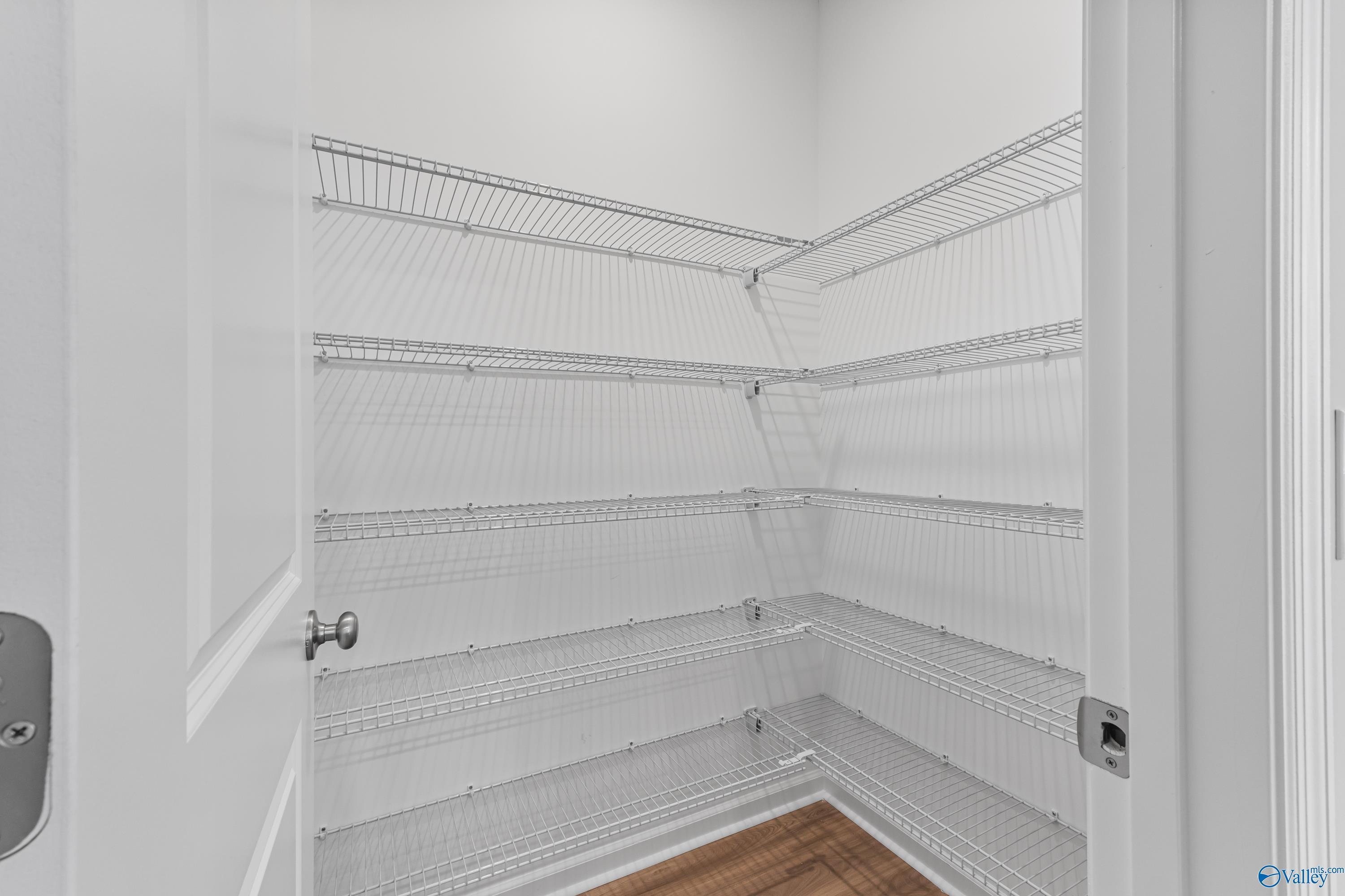 Walk-in closet with white wire shelving and ample storage in The Aurora 4-bedroom home by Davidson Homes, Fayetteville, Tennessee