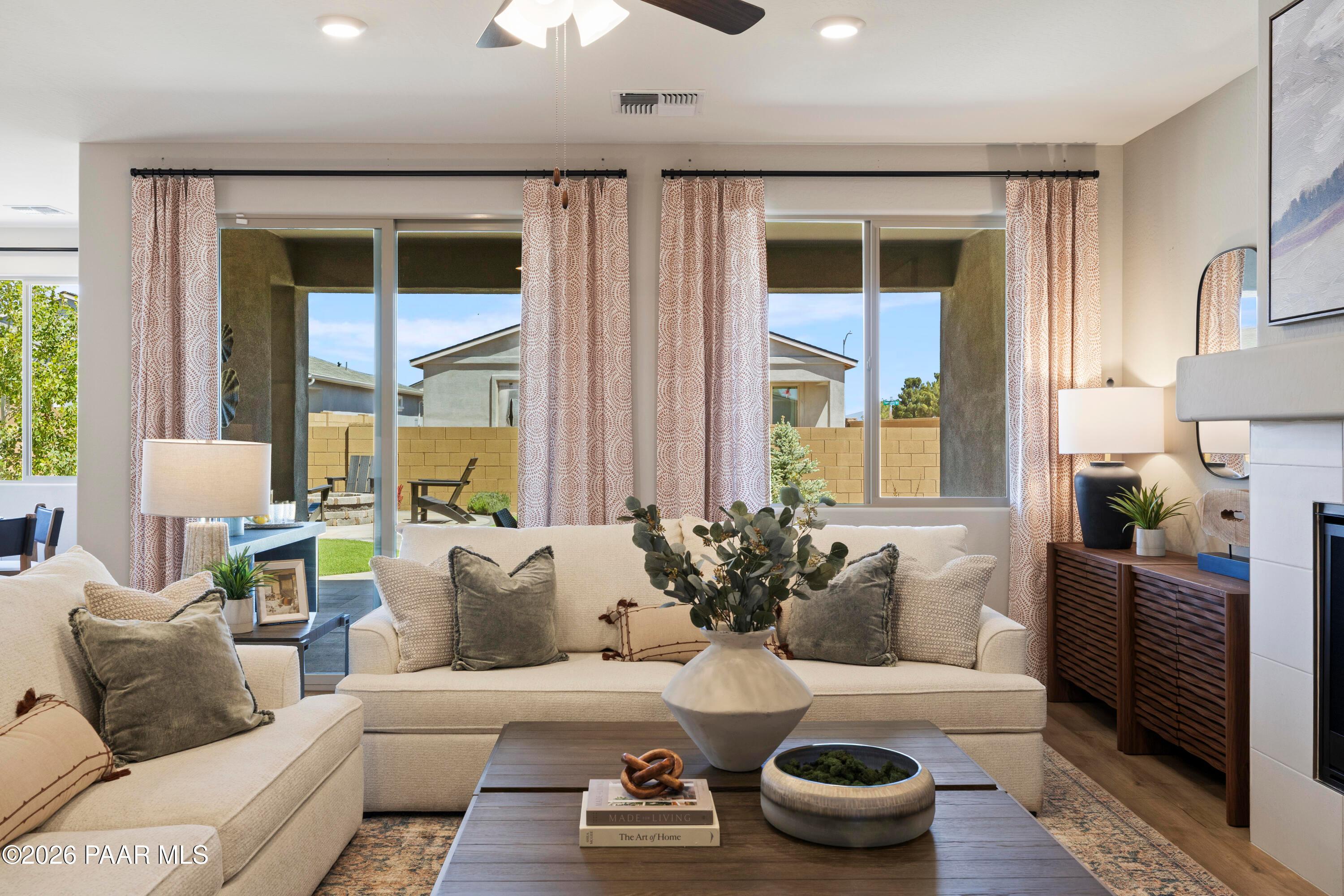 Bright living room with large sliding glass doors in The Harmony A floor plan at Pronghorn Ranch, Prescott Valley.