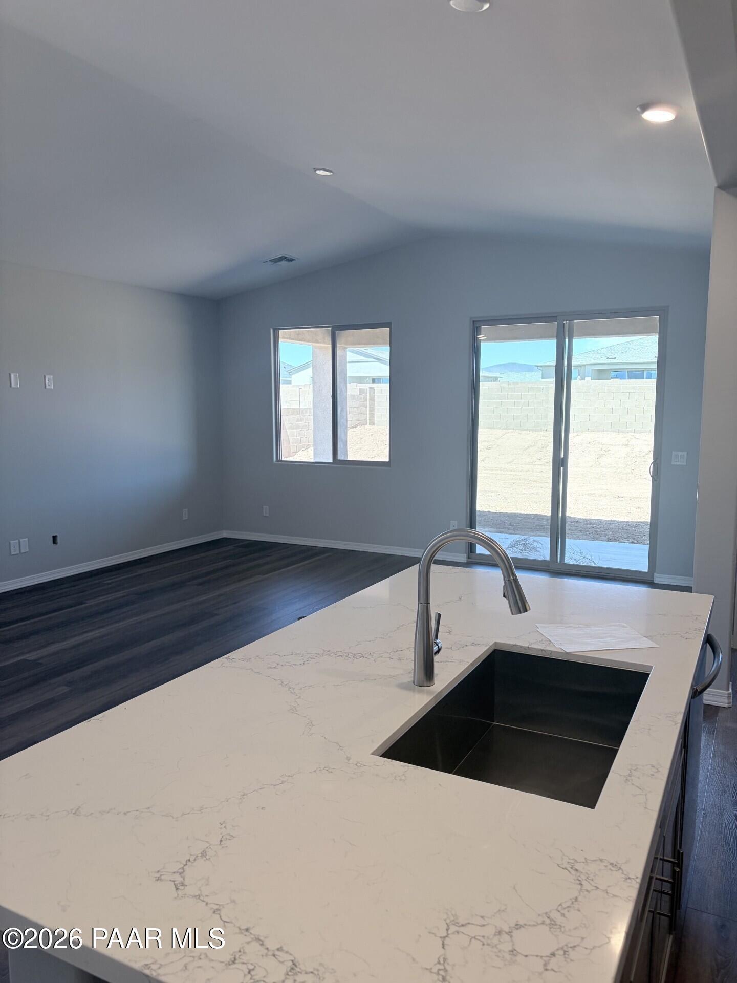 Modern kitchen island with quartz countertops in The Frontier A floor plan at North Ridge, Pronghorn Ranch, Prescott Valley.