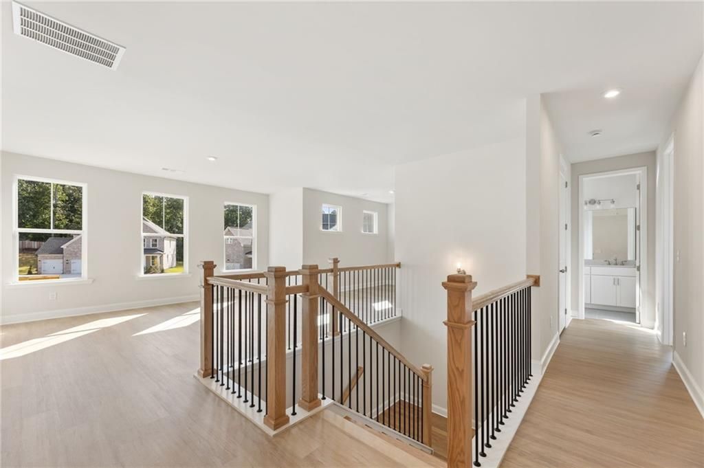 Elegant open staircase with wood treads and black railings in The Hampton C 4-bedroom home, Davidson Homes, Buford, Georgia