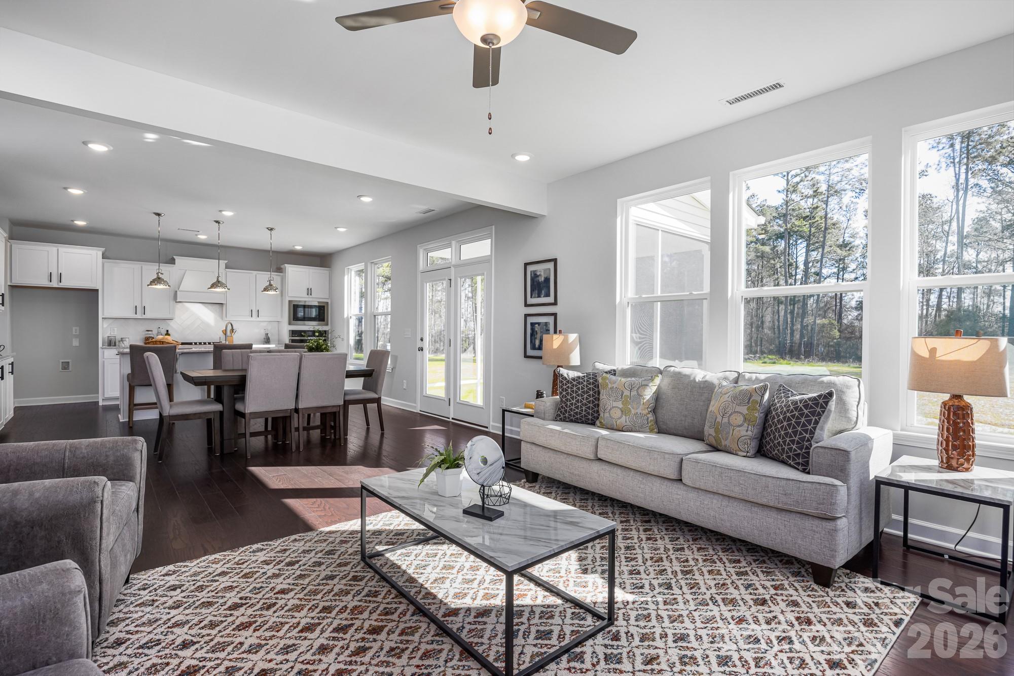 Open-concept living room and kitchen in The Hemlock D floor plan at Enclave at Belmont, Belmont, North Carolina.