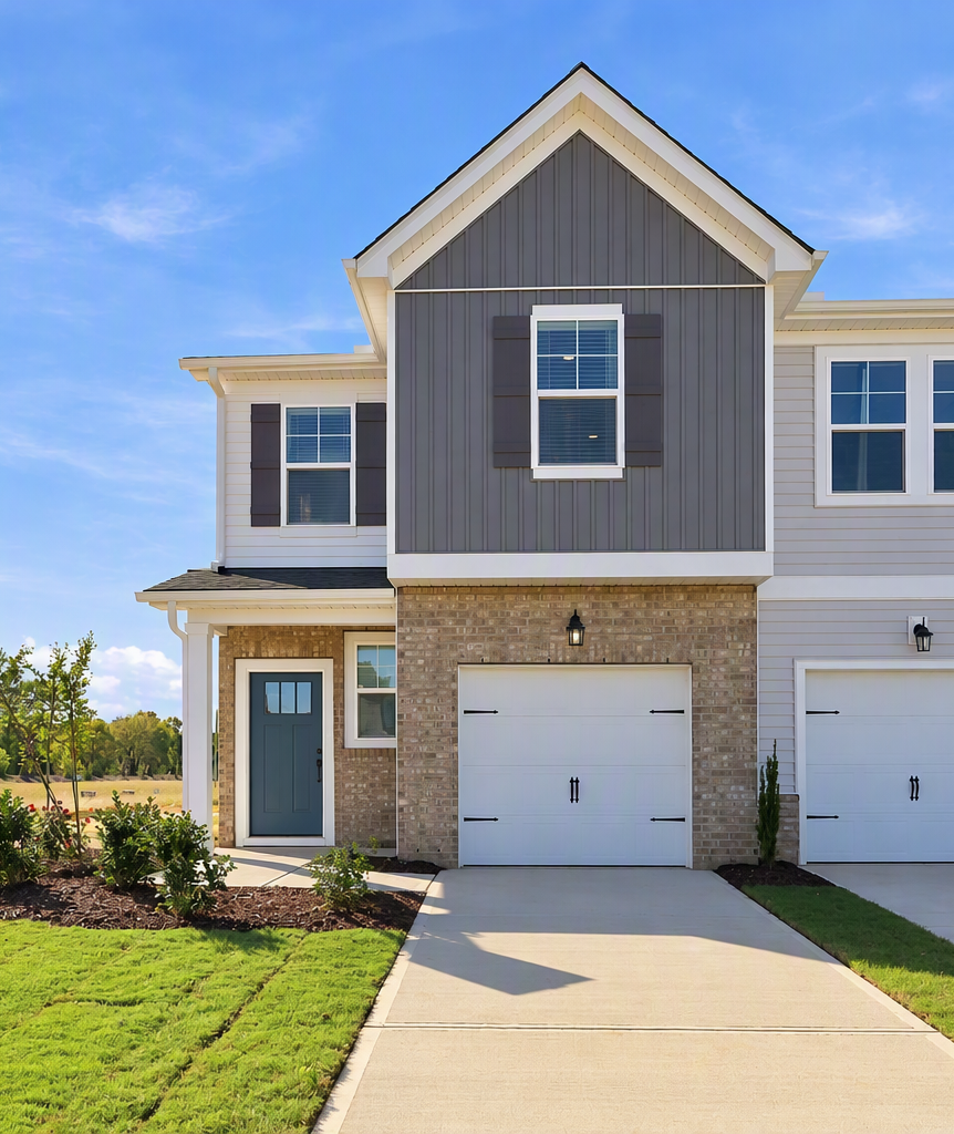 Two-story townhouse exterior at Townes at North Main in Lillington, NC by Davidson Homes with attached garages and landscaped lawn