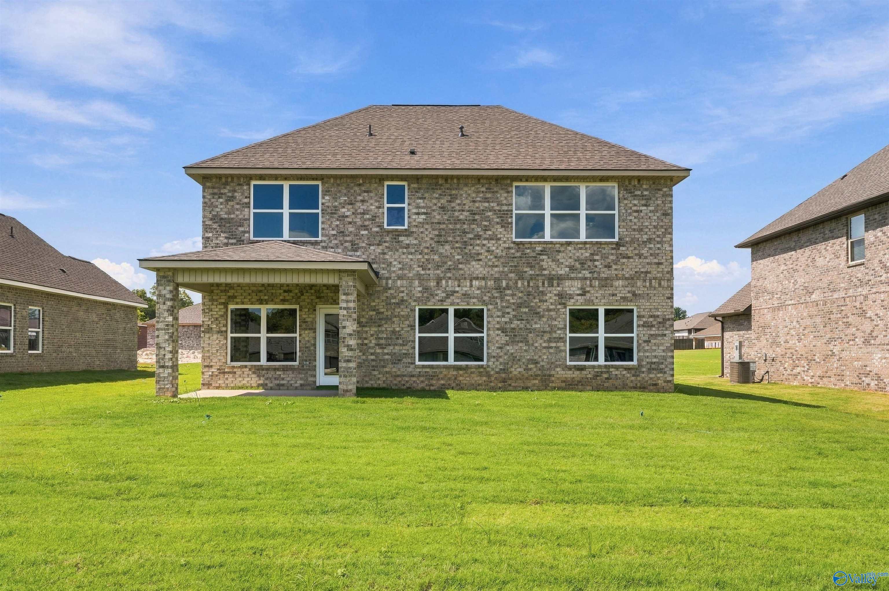 Two-story brick home with covered patio and spacious backyard in The Meadows, Davidson Homes The Shelby A, Athens, Alabama