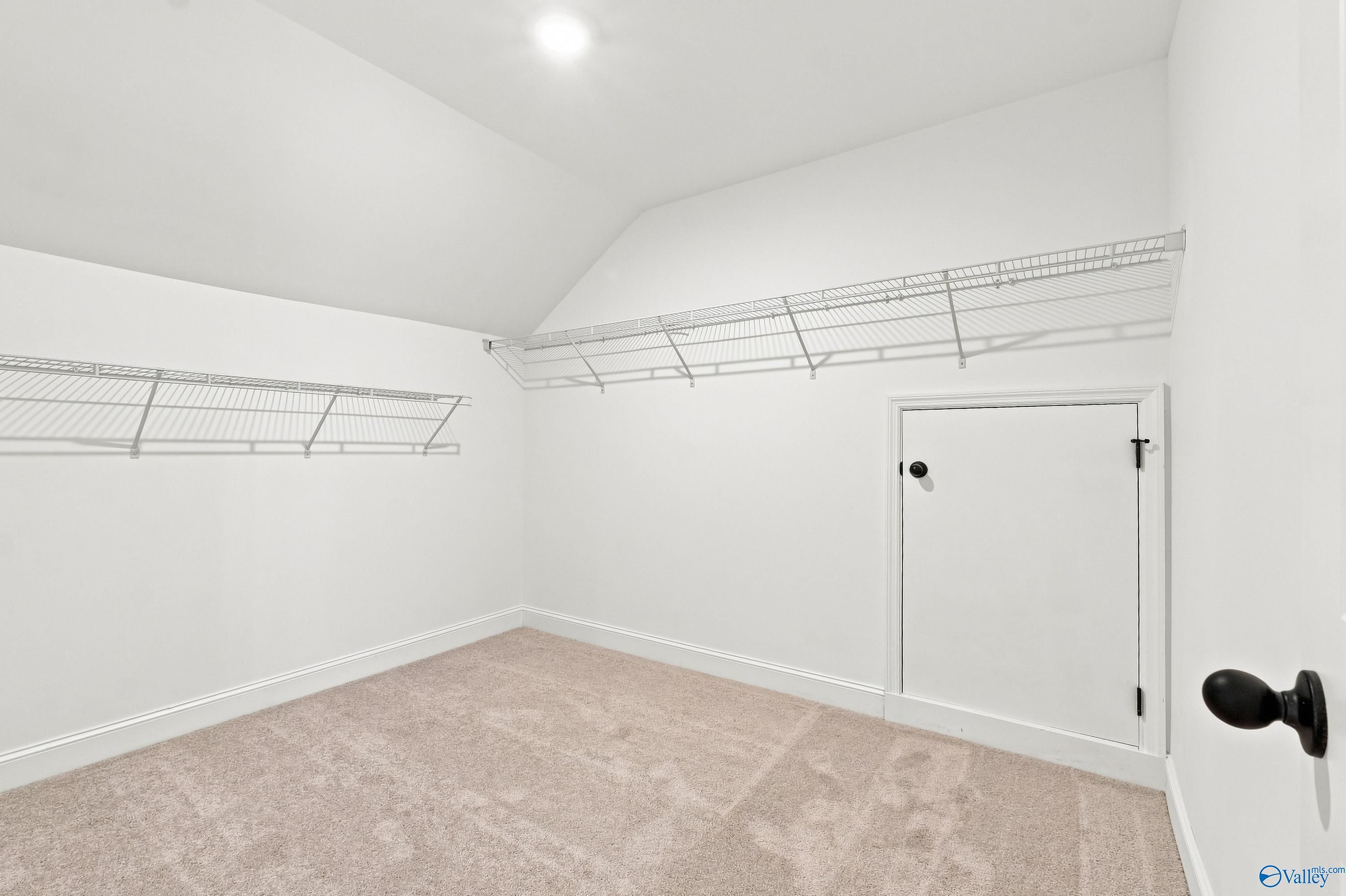 Walk-in storage closet with shelving in The Rockford B floor plan at Kendall Downs in Toney, Alabama.