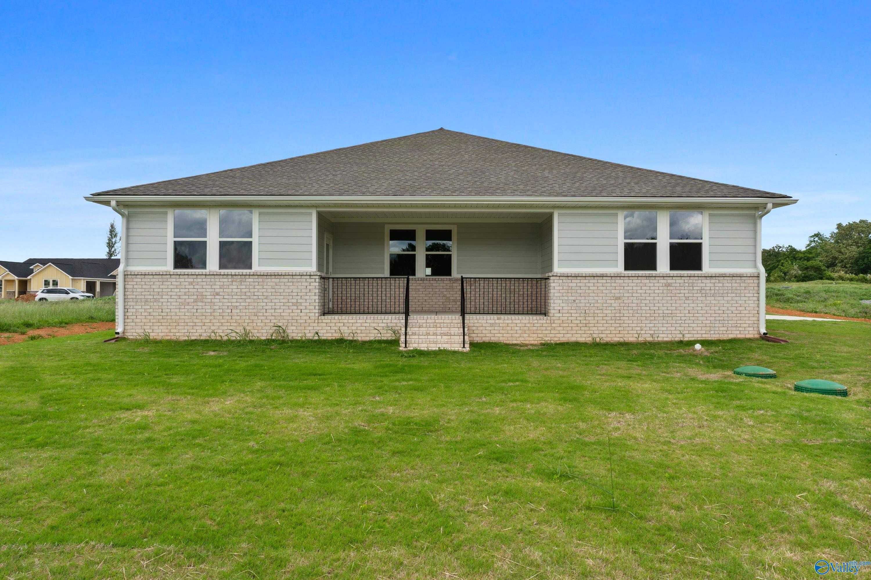 Two-story brick home with covered front porch, large windows, and 3-car garage in Riverton Preserve, Huntsville, Alabama – Davidson Homes The Haven