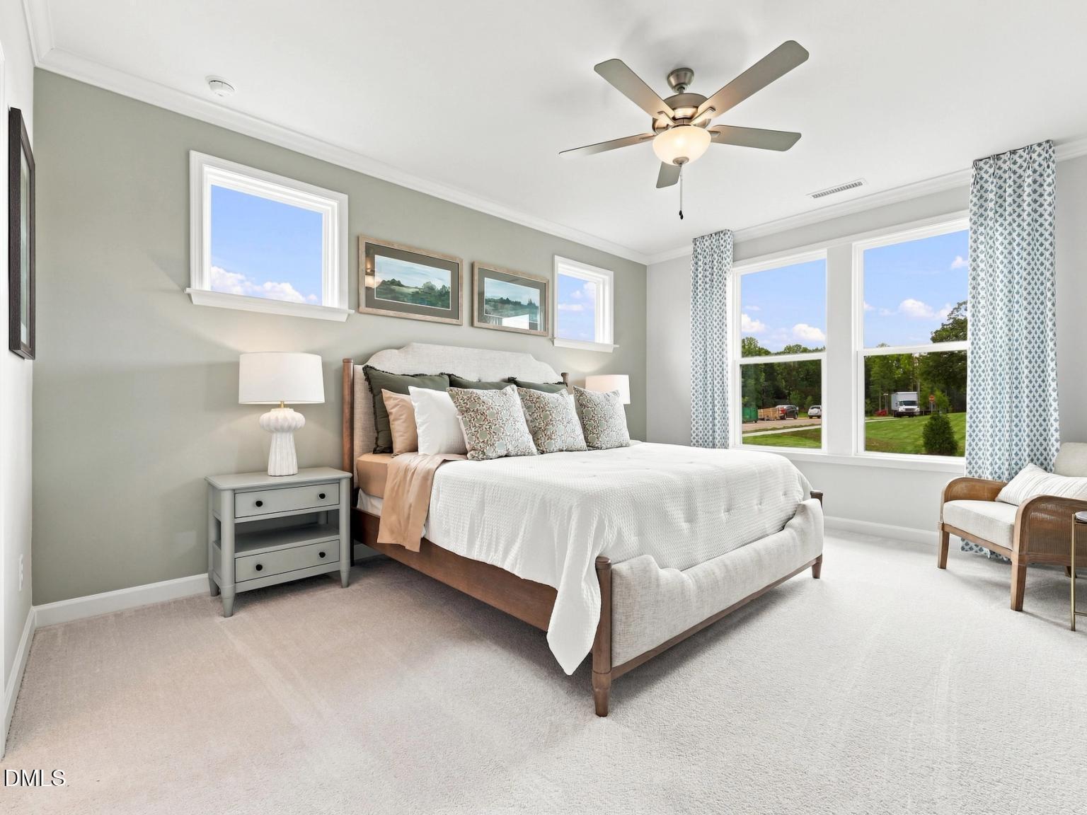 Spacious master bedroom with upholstered bed in The Daphne C floor plan at Woodland Crossing, Zebulon, North Carolina.