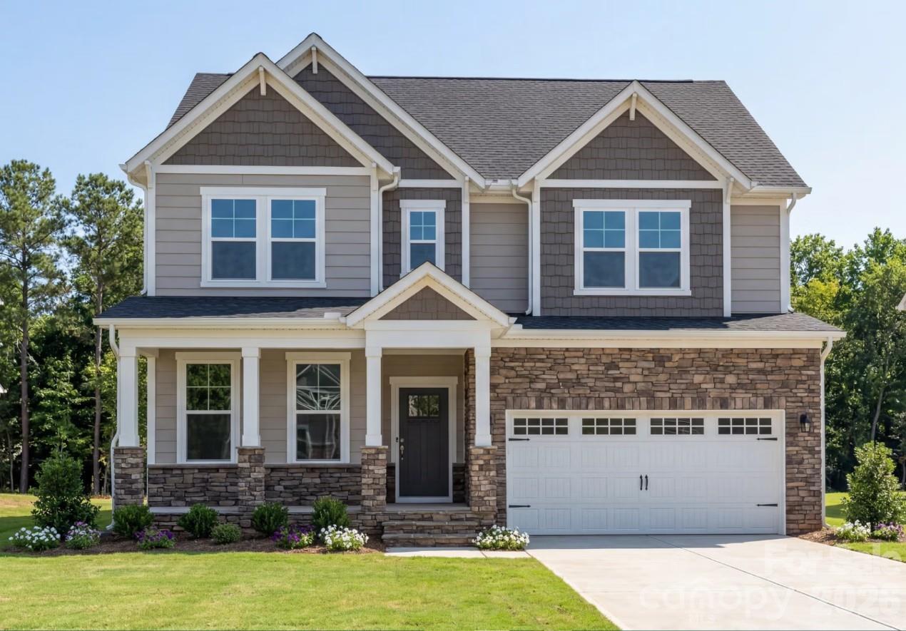 Three-story Chestnut D floor plan by Davidson Homes with stone facade and two-car garage in Enclave at Belmont, NC.