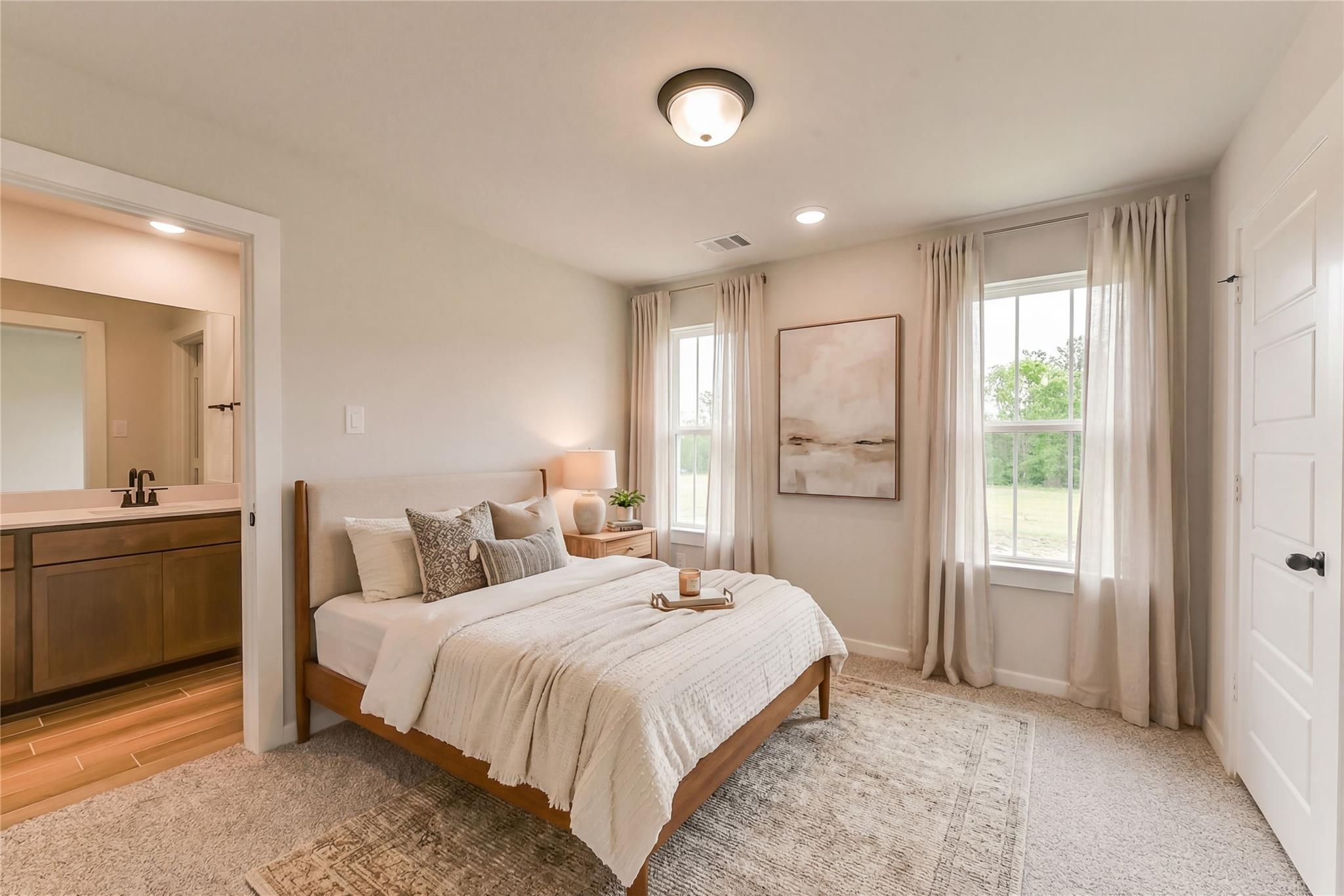 Serene master bedroom suite with en-suite bath, king bed, abstract art, and garden views in Davidson Homes Sequoia C, Crosby TX