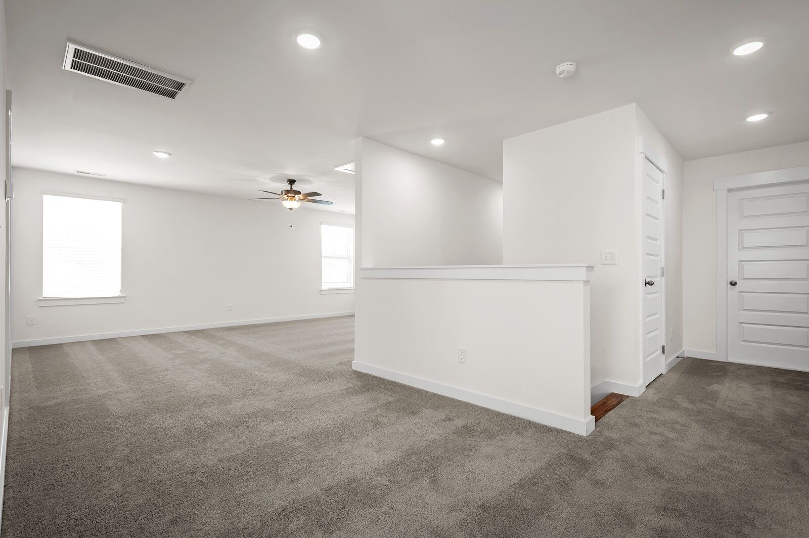 Spacious carpeted loft area in The Ash A floor plan at Woods Crossing in Gallatin, Tennessee by Davidson Homes.