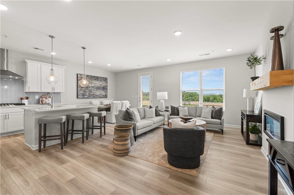 Open-concept living room and kitchen in The Wake B floor plan by Davidson Homes at Hemingway in Cumming, GA.