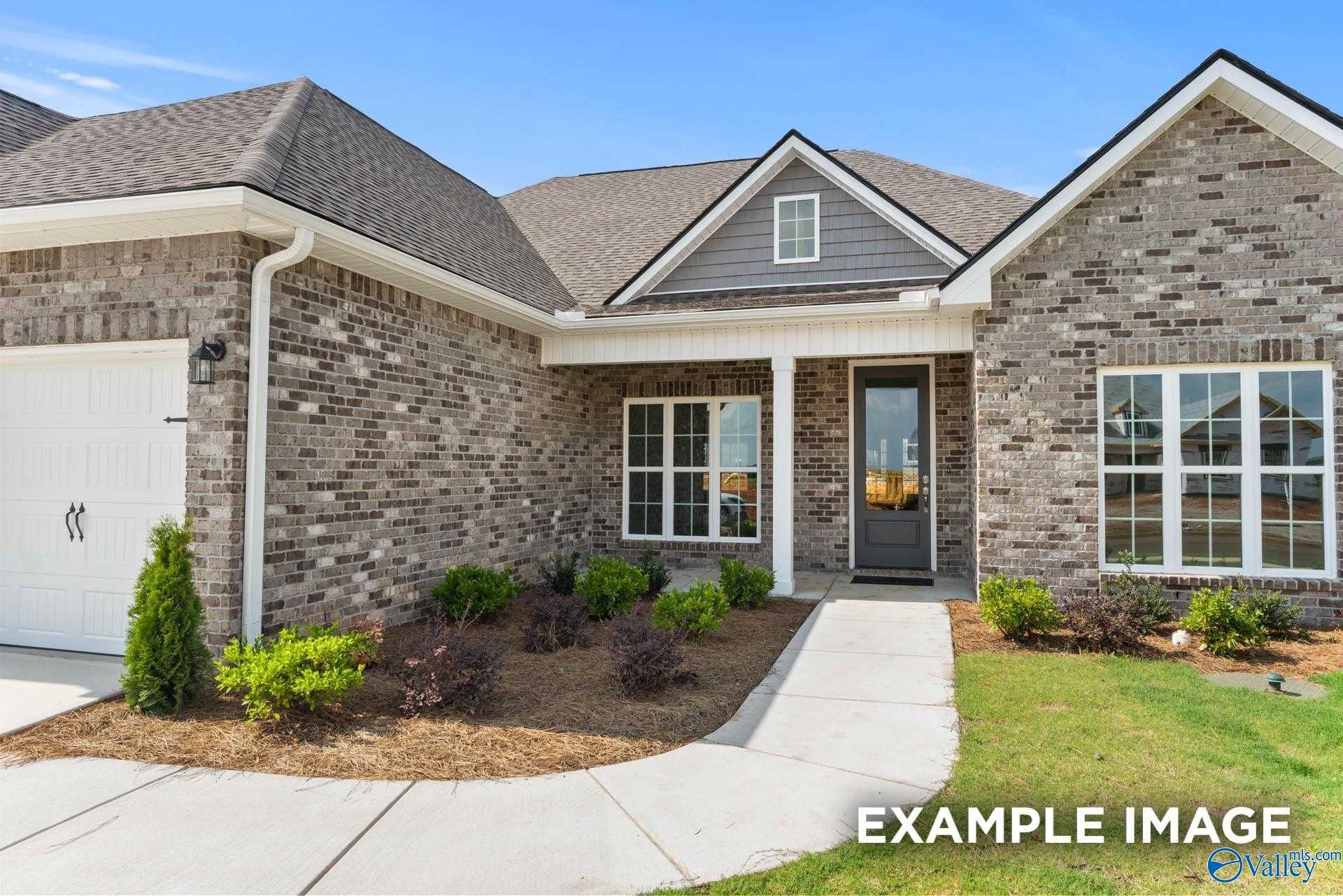 Modern brick single-story home exterior with 2-car garage, front door, windows, and landscaped yard in Briercreek, Meridianville, Alabama