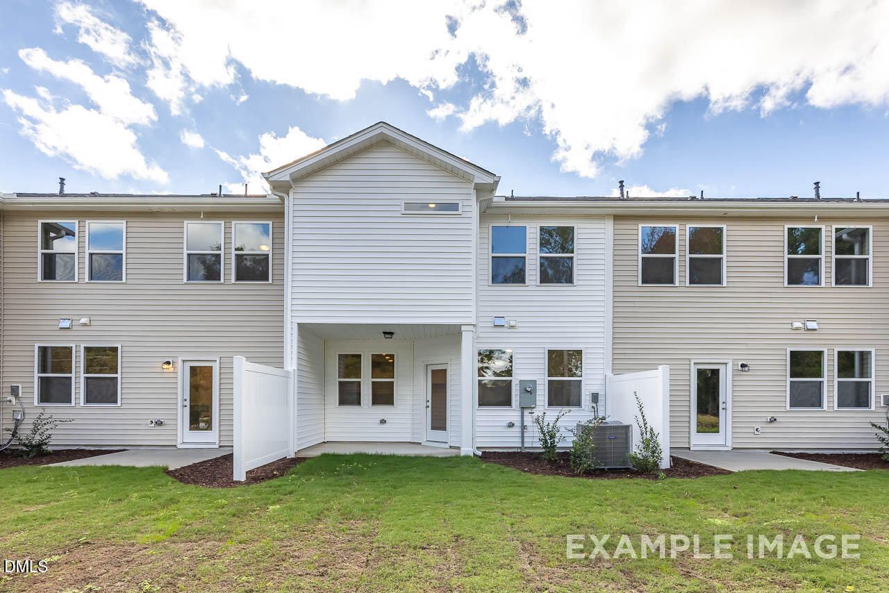 Modern two-story 3-bedroom Graham home exterior with white siding, 1-car garage, and landscaped yard in Springvale, Fuquay-Varina, NC