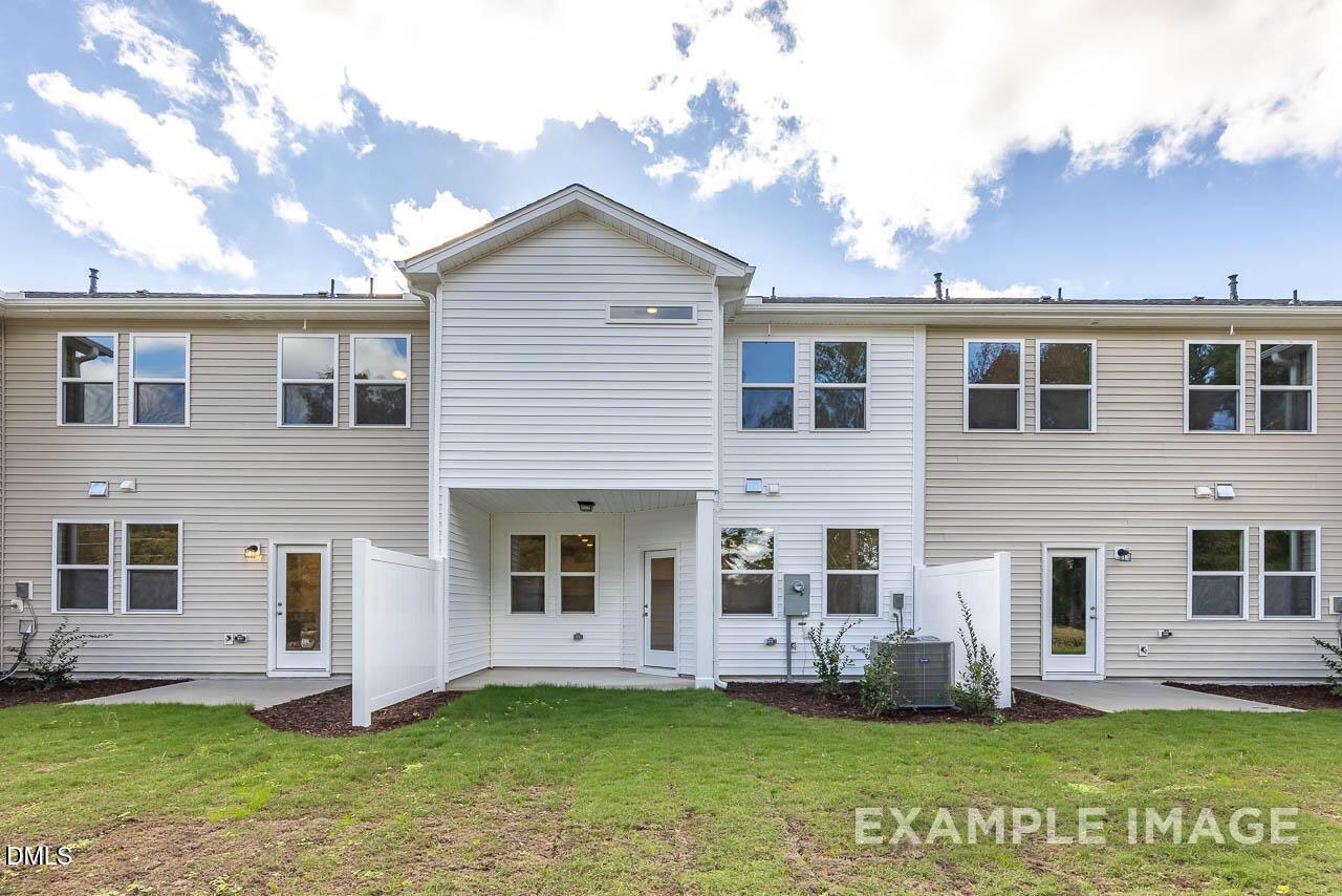 Modern two-story 3-bedroom Graham home exterior with white siding, 1-car garage, and landscaped yard in Springvale, Fuquay-Varina, NC