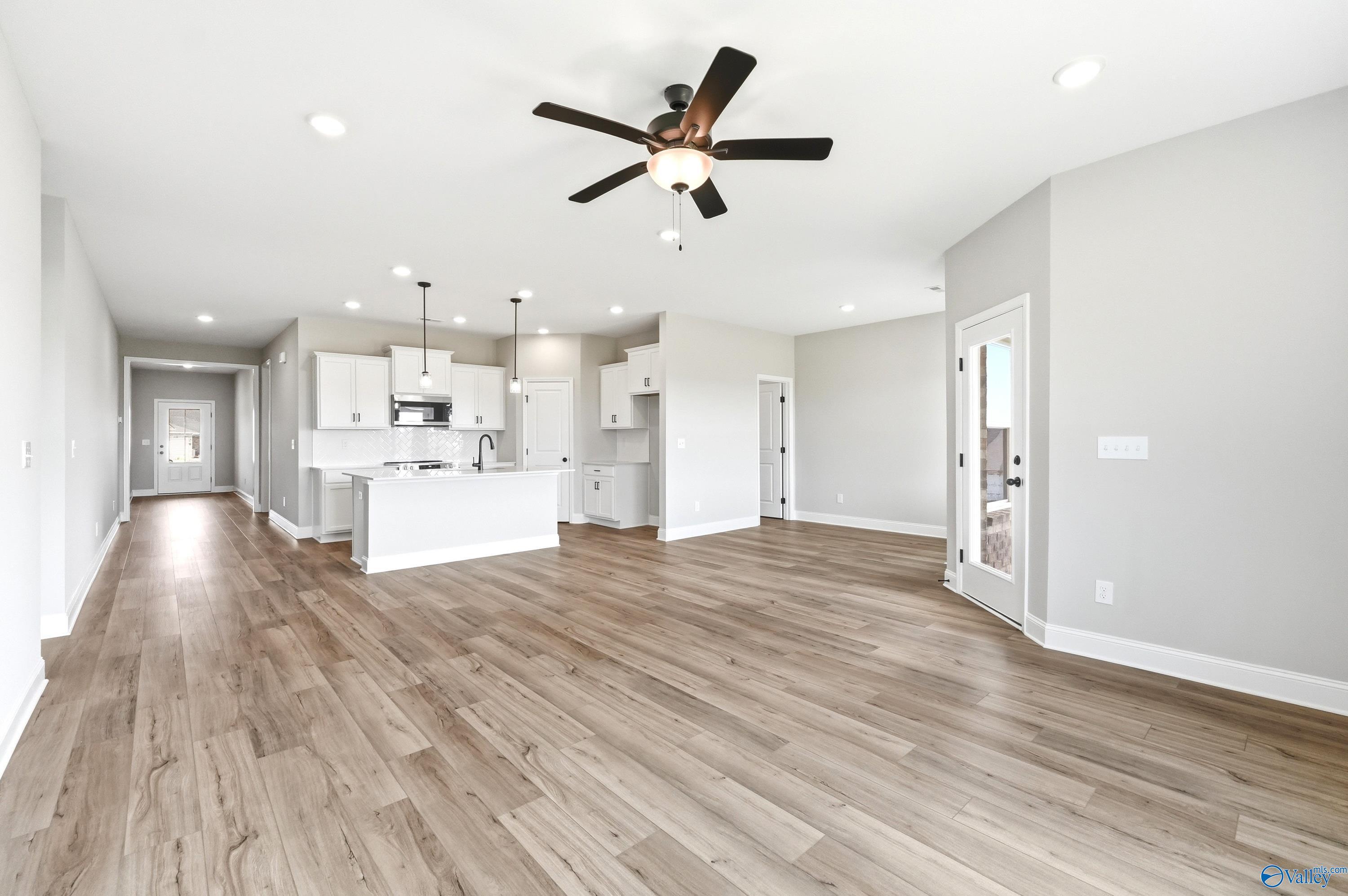 Open-concept living room and kitchen in The Daphne D floor plan by Davidson Homes in Creekside, Harvest, Alabama.