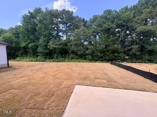 Private backyard with fresh sod and concrete patio at The Willow B in Woodland Crossing, Zebulon, North Carolina.