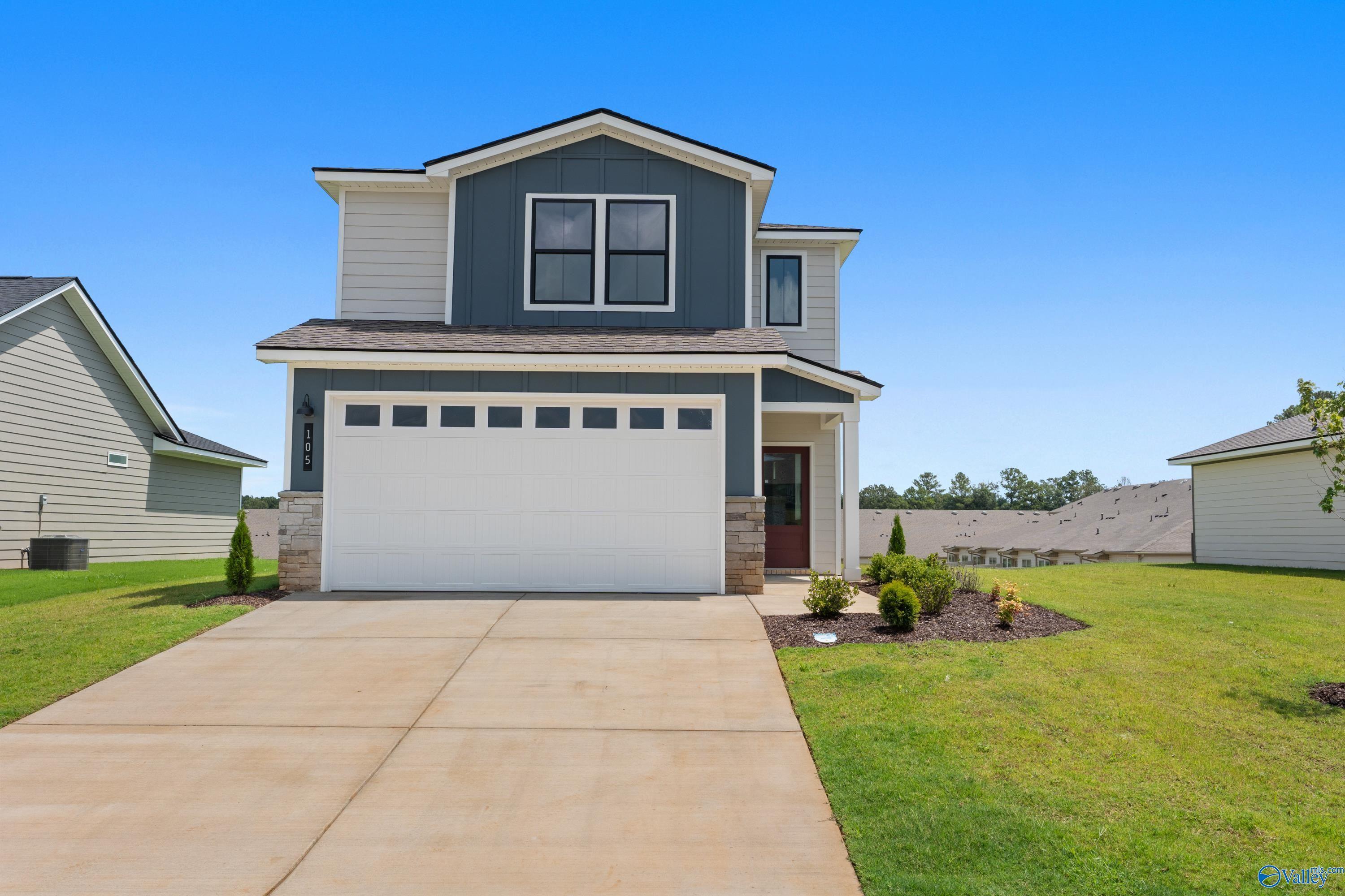 Modern 2-story gray home with 2-car garage, red door, driveway, and landscaped yard in Evergreen Mill, Madison, Alabama - Davidson Homes The Augusta
