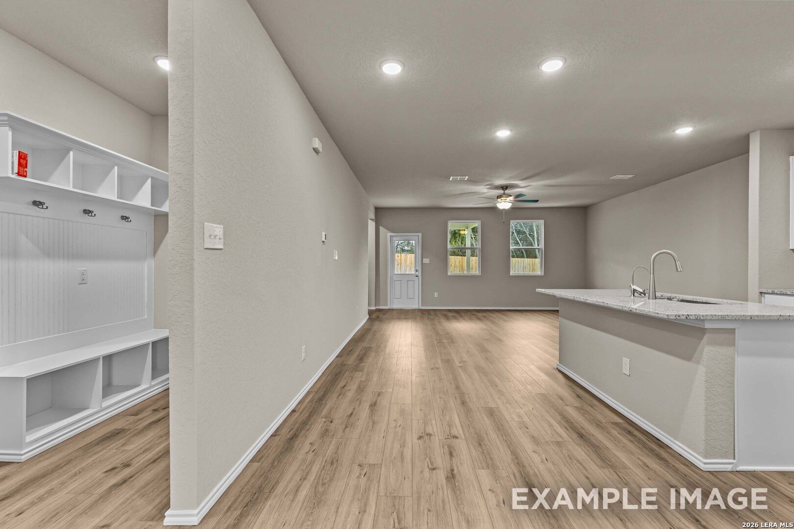 Open-concept kitchen and mudroom with built-in storage in The Douglas F floor plan at Bricewood, San Antonio, Texas.