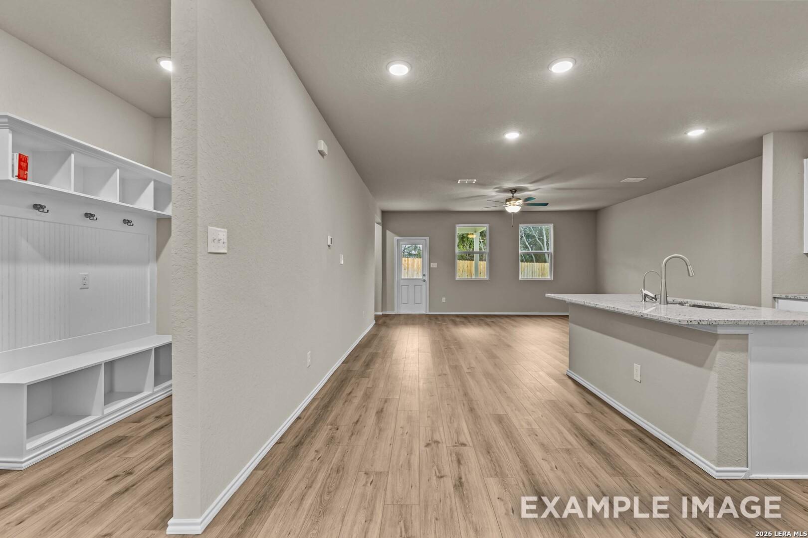 Open-concept kitchen and mudroom with built-in storage in The Douglas F floor plan at Bricewood, San Antonio, Texas.