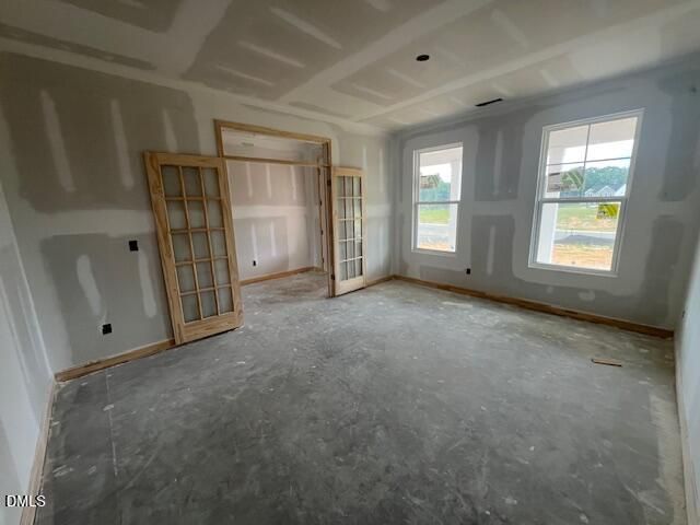 Unfinished room with French doors in The Hickory II C floor plan at Retreat at North Main, Lillington, NC.