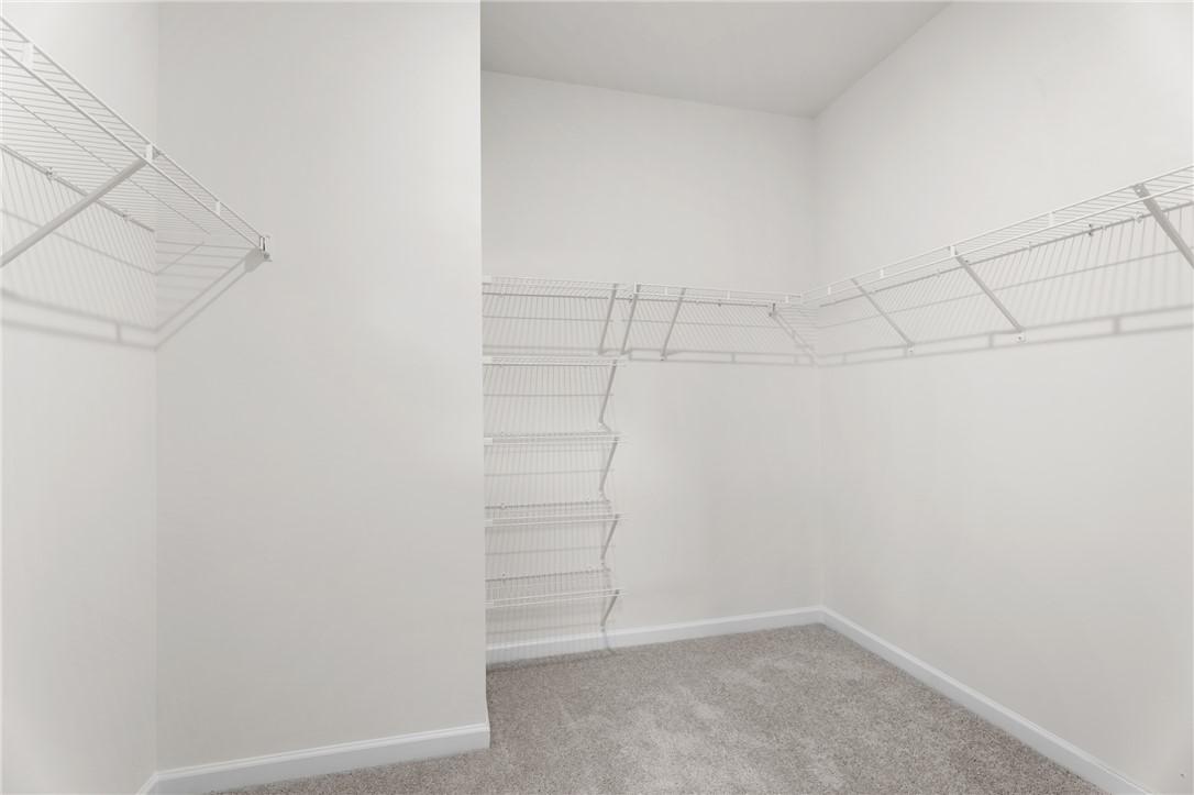 Spacious walk-in closet with white wire shelving in The Stella D floor plan at Silver Oak, Cusseta, Alabama.