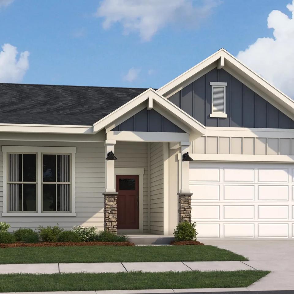 Modern craftsman ranch home exterior at Cape Reserve Donahue Ridge in Auburn Alabama with gabled roof stone accents and covered porch
