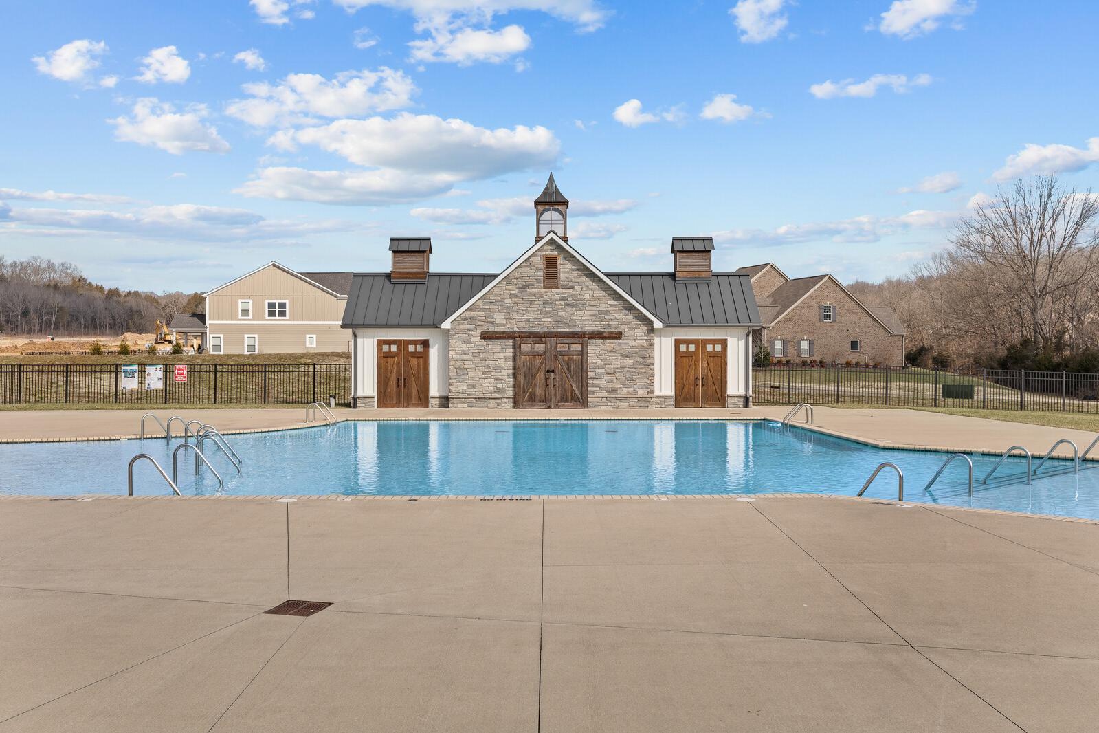 Resort-style swimming pool and clubhouse at Carellton in Gallatin TN with clock steeple, barn doors and fenced deck