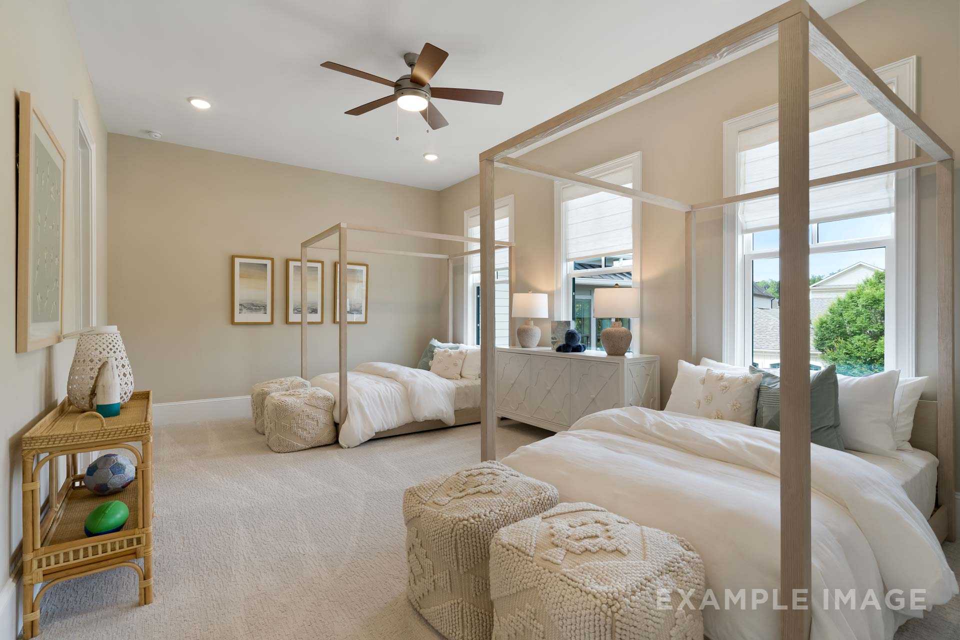 Spacious twin canopy bedroom in The Seaside Davidson Homes design, Woodstock GA, with beige walls, ceiling fan, and neutral decor