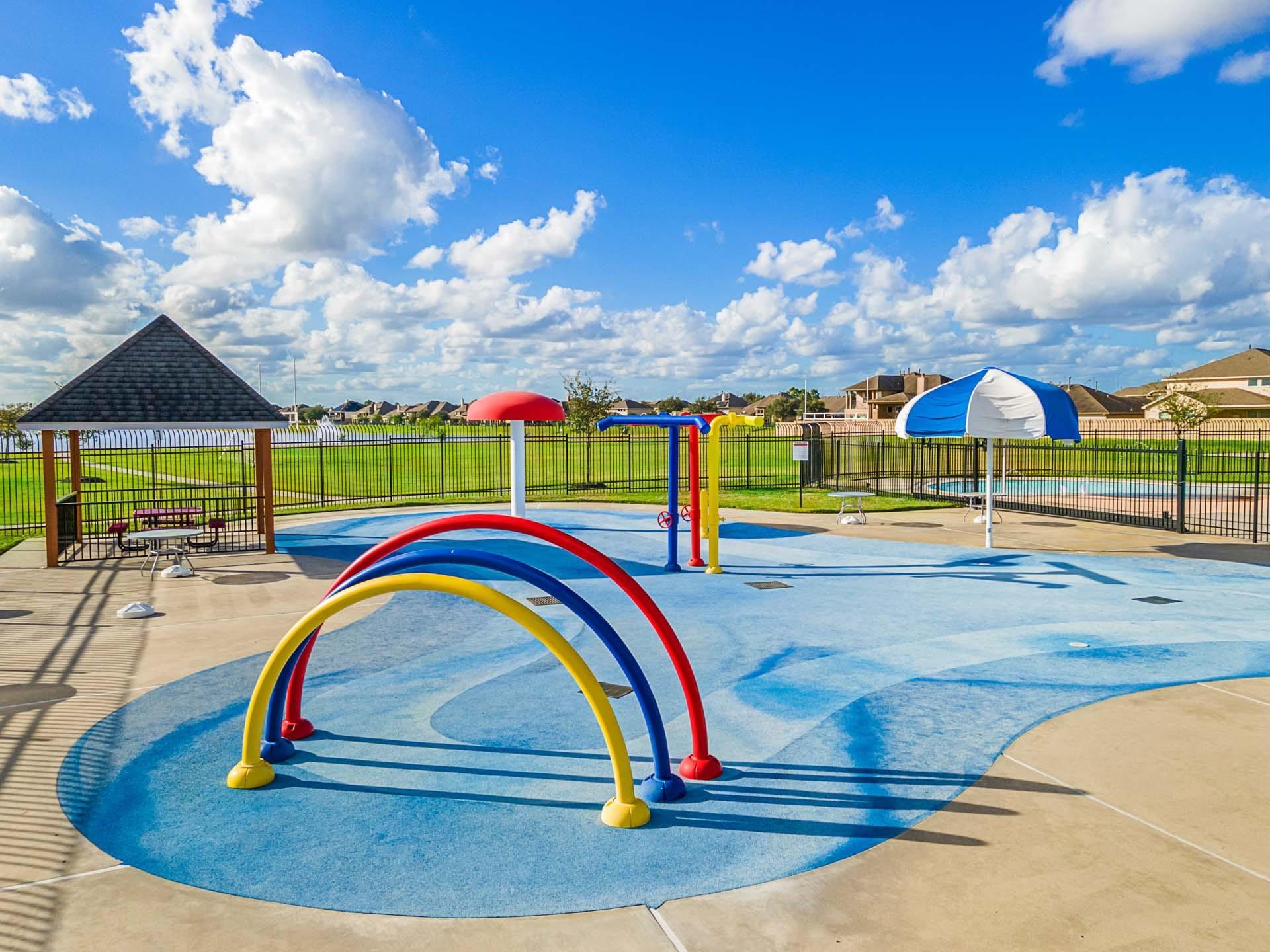Colorful splash pad with water features at the community amenities center in Sierra Vista, Rosharon, Texas.