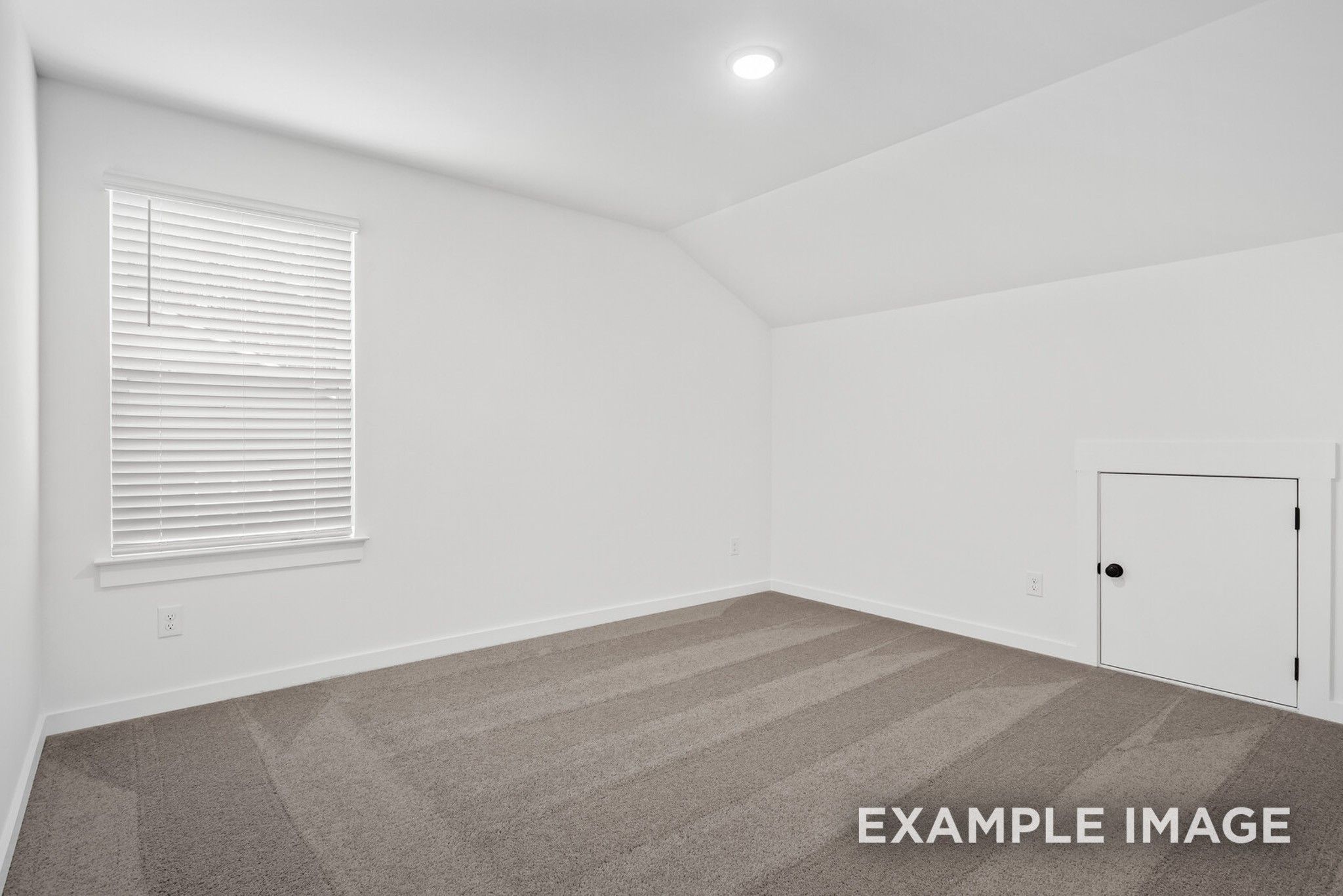 Bright upstairs bedroom with vaulted ceiling, white blinds, carpeted floor in Davidson Homes The Ridgeport C, Gallatin, Tennessee