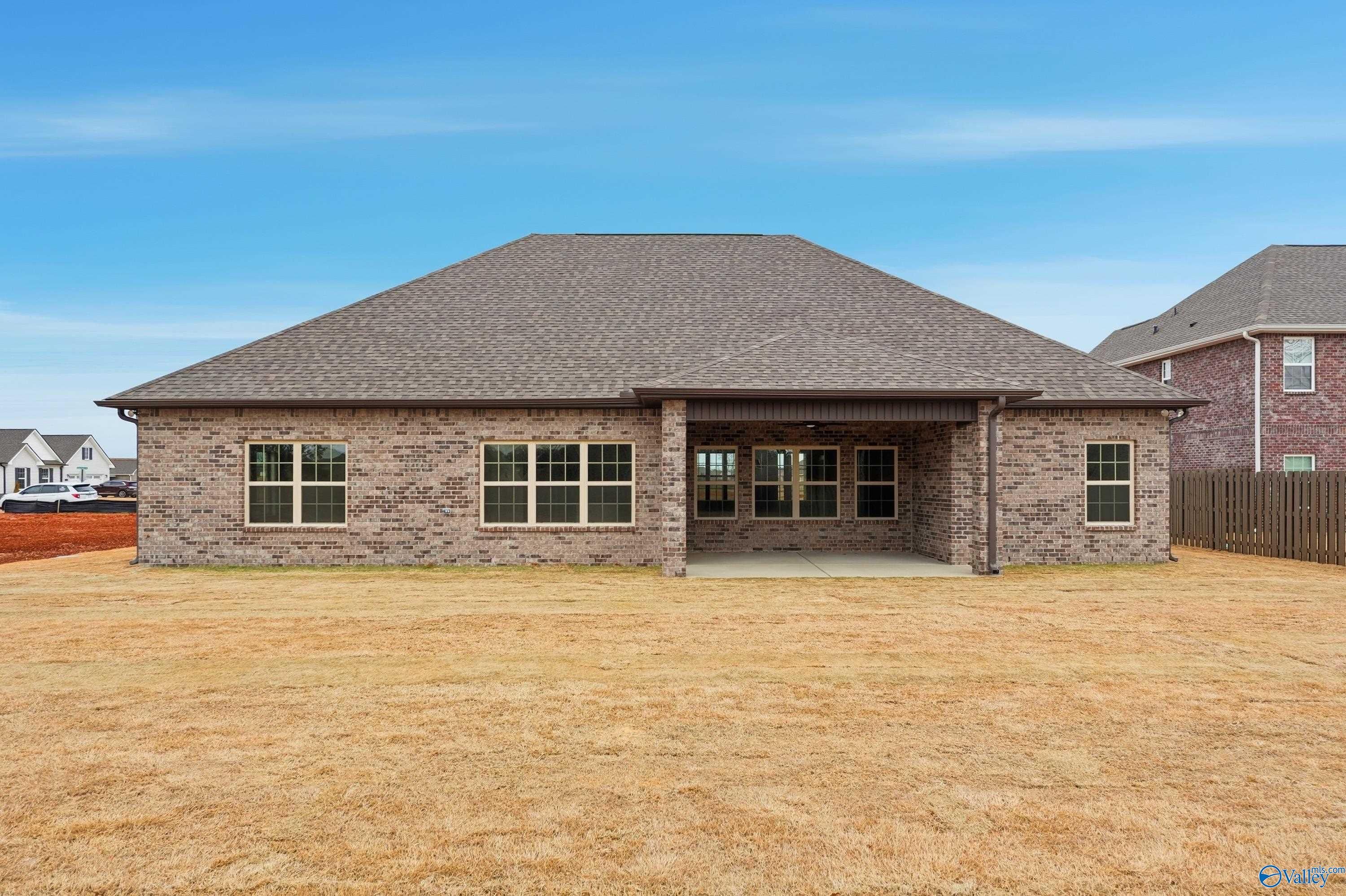 Single-story brick home with covered back porch, gabled roof, and fenced yard in Briercreek, Meridianville, Alabama