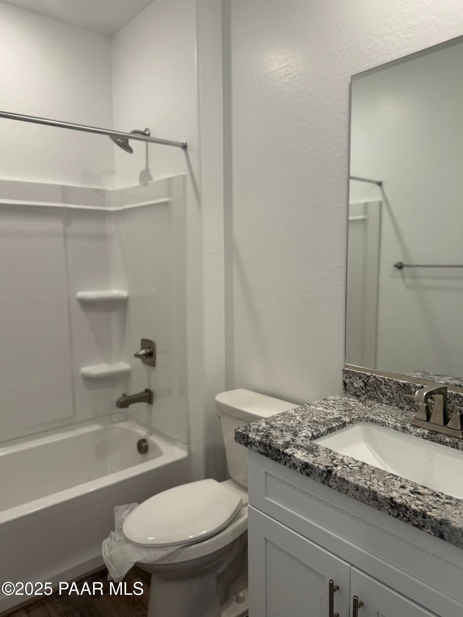 Modern master bathroom with granite vanity, soaking tub, and glass shower enclosure in Davidson Homes The Sunrise II A, Prescott, Arizona