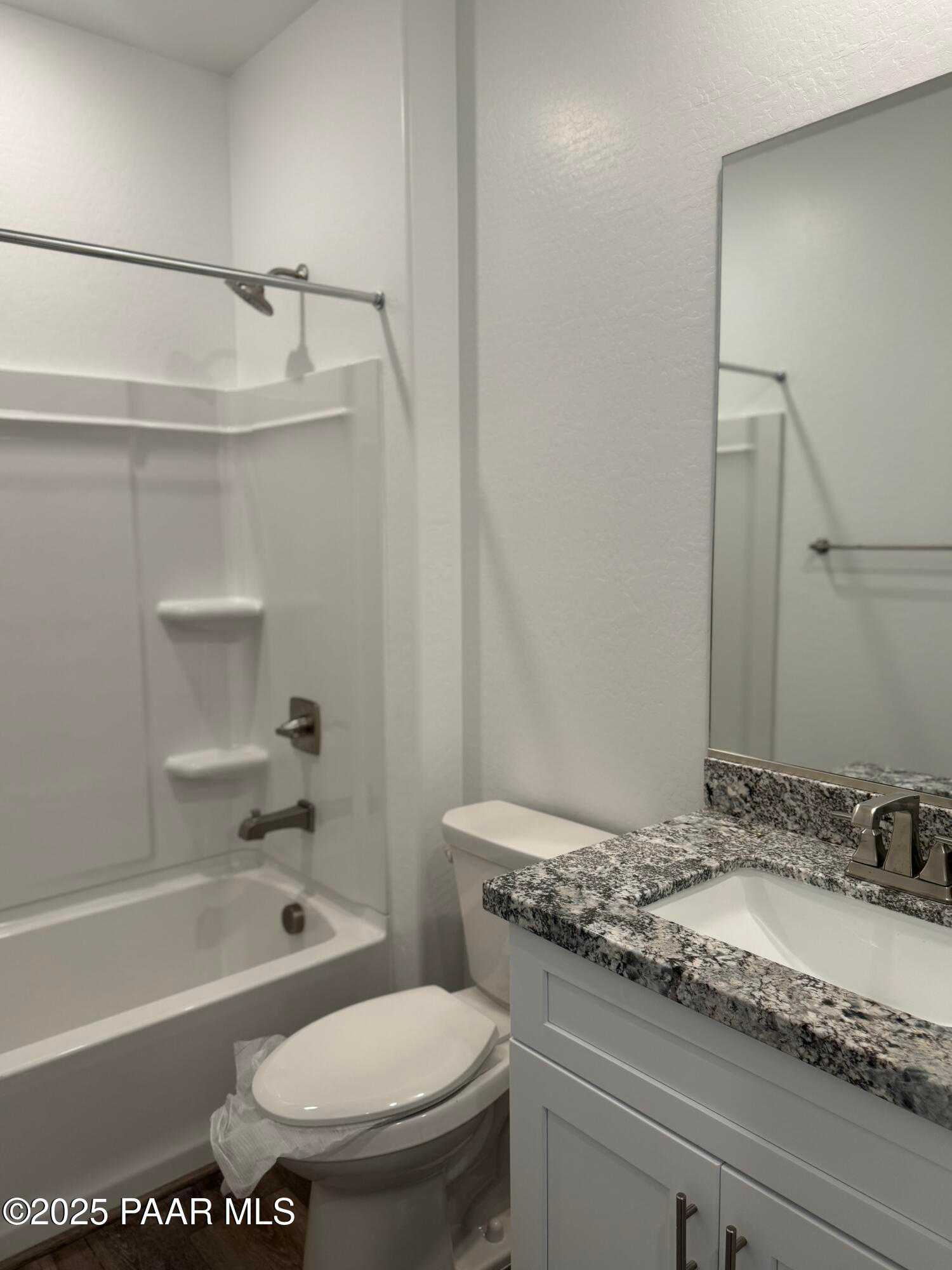 Modern master bathroom with granite vanity, soaking tub, and glass shower enclosure in Davidson Homes The Sunrise II A, Prescott, Arizona