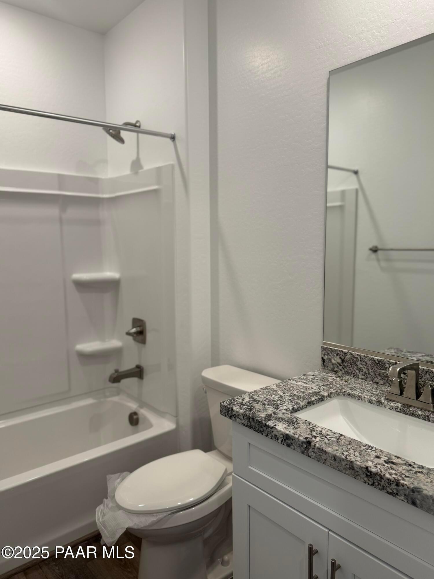 Modern master bathroom with granite vanity, soaking tub, and glass shower enclosure in Davidson Homes The Sunrise II A, Prescott, Arizona