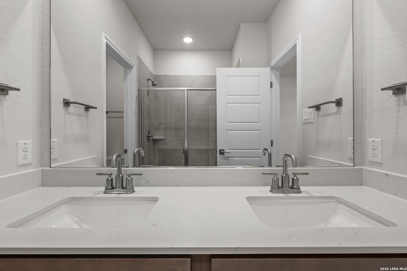 Dual vanity bathroom with quartz countertops in Davidson Homes The San Marcos F floor plan, Rayburn Valley, San Antonio.