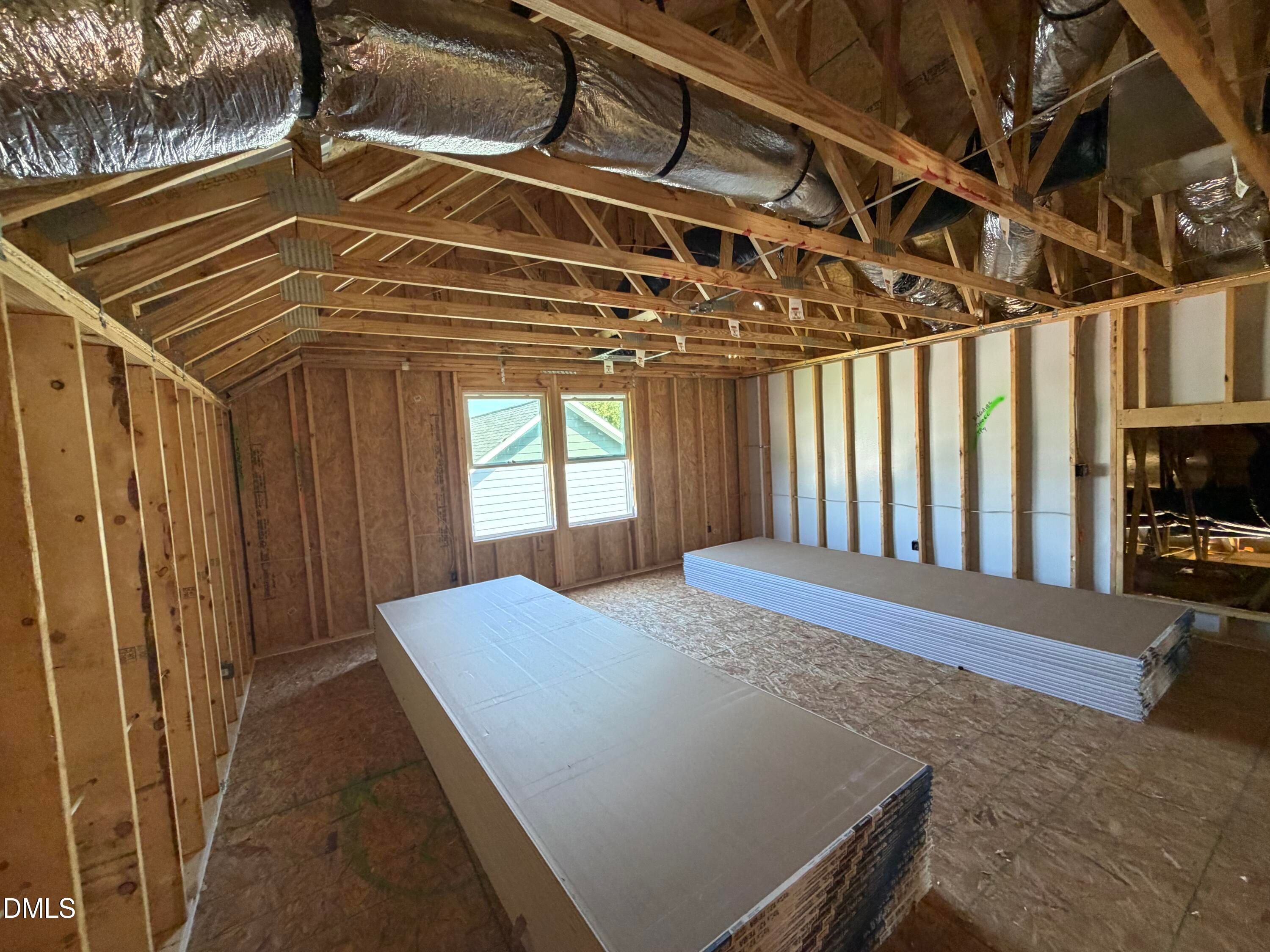 Unfinished upstairs bonus room with exposed framing and ductwork in The Aspen C floor plan by Davidson Homes, Wendell Ridge, NC