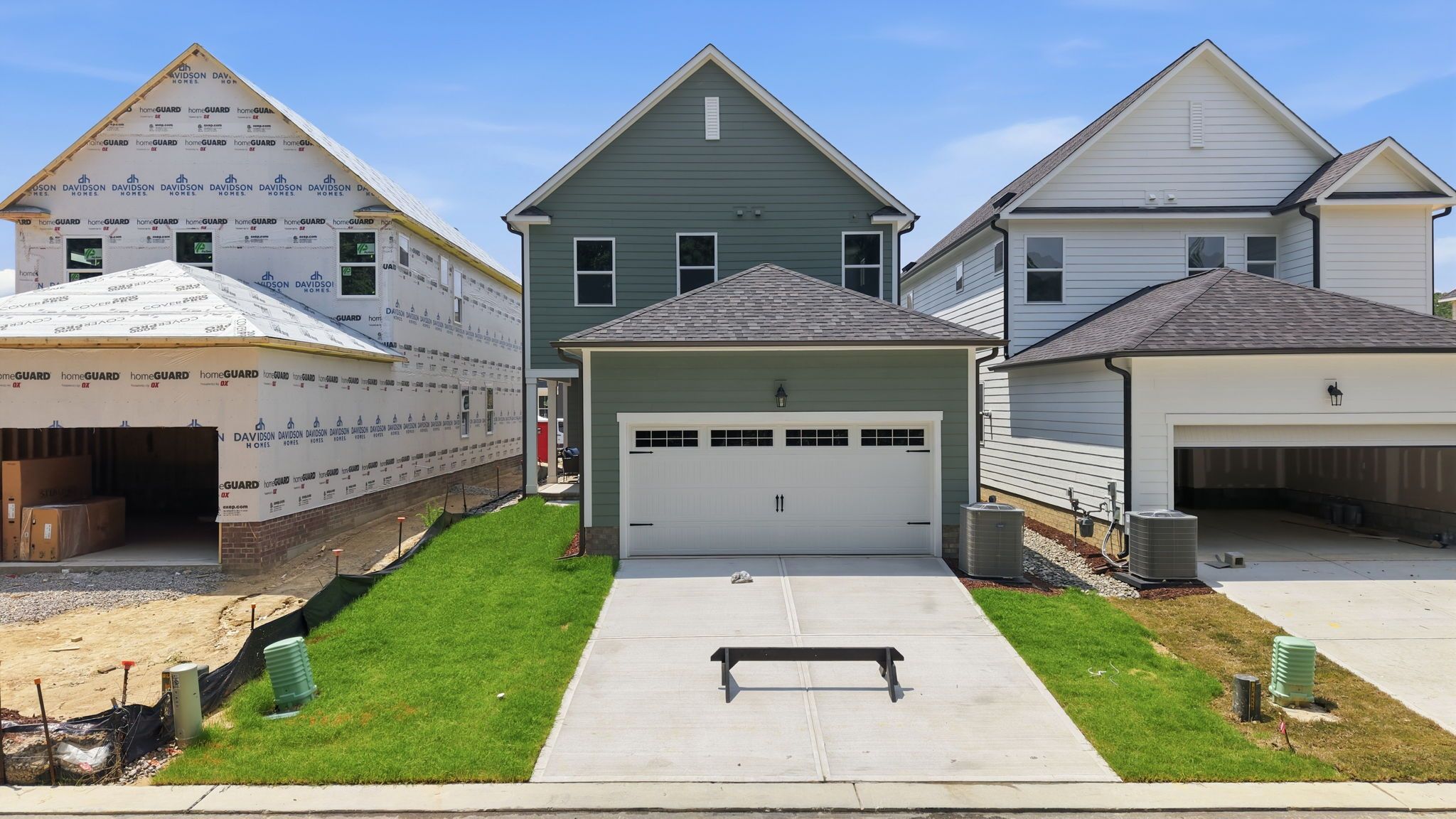 The Jordan A 2-story single-family home by Davidson Homes in Knightdale, NC, featuring a 2-car garage and green exterior.