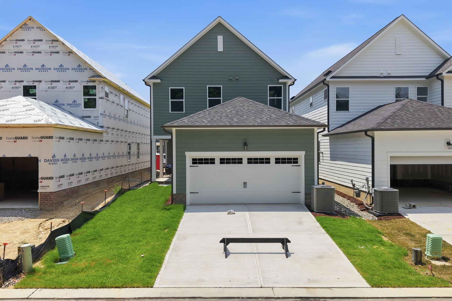 The Jordan A 2-story single-family home by Davidson Homes in Knightdale, NC, featuring a 2-car garage and green exterior.