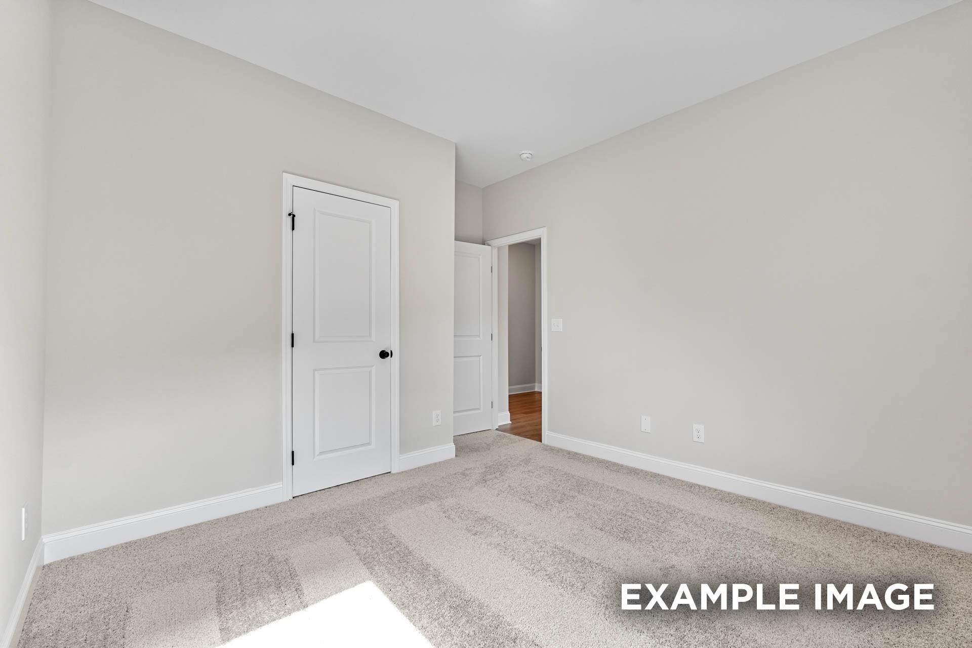 Spacious neutral-toned bedroom with plush carpet in The Franklin E floor plan at Bailey Park, Fayetteville, Tennessee.