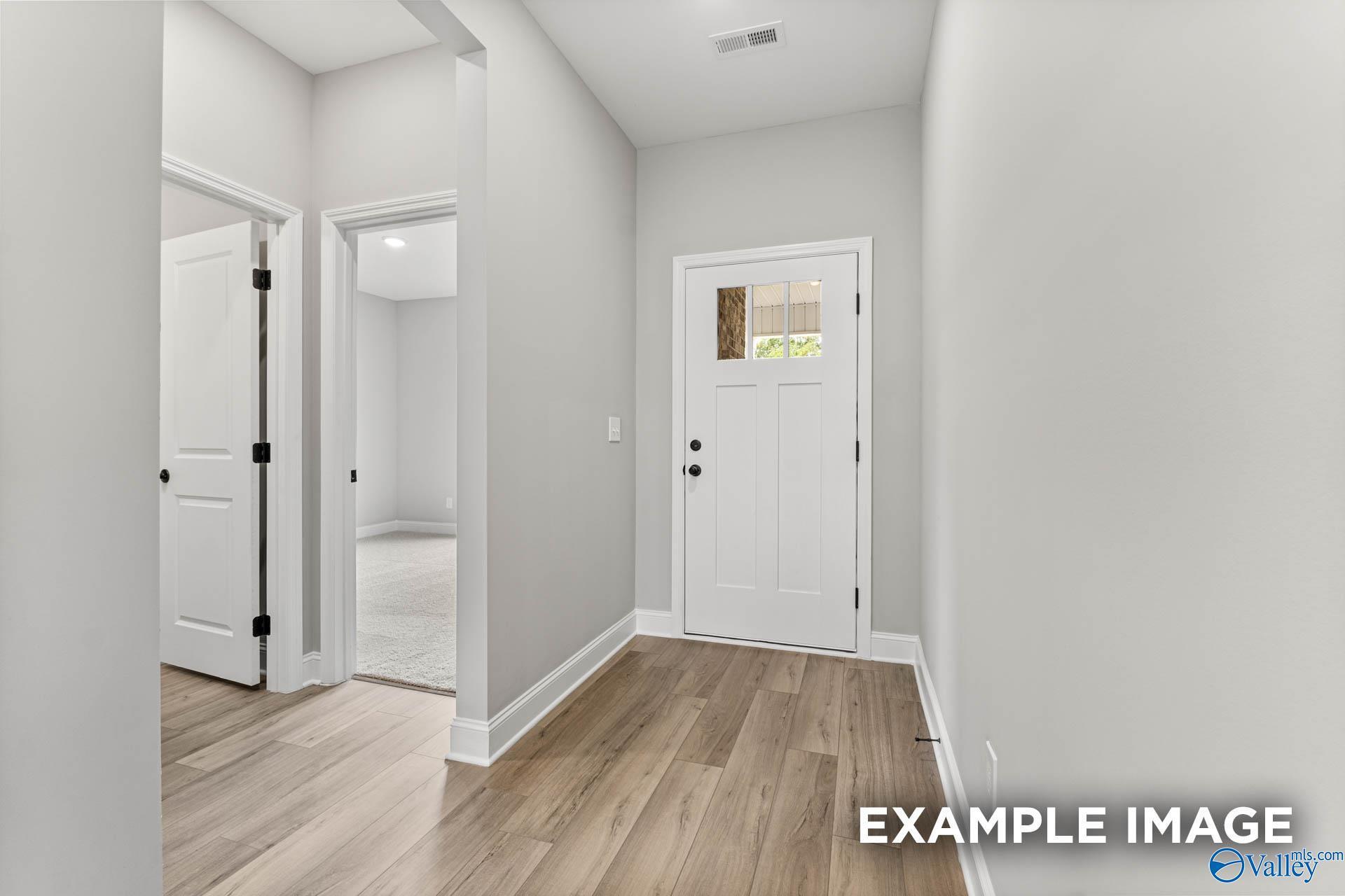 Bright foyer entry with wood-look flooring in The Franklin C floor plan by Davidson Homes in Ricketts Farm, Athens, Alabama.
