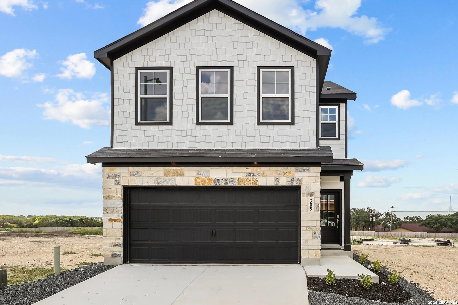 Two-story Gillian B floor plan by Davidson Homes with stone facade and 2-car garage in Meadows at Oak Creek, San Antonio.