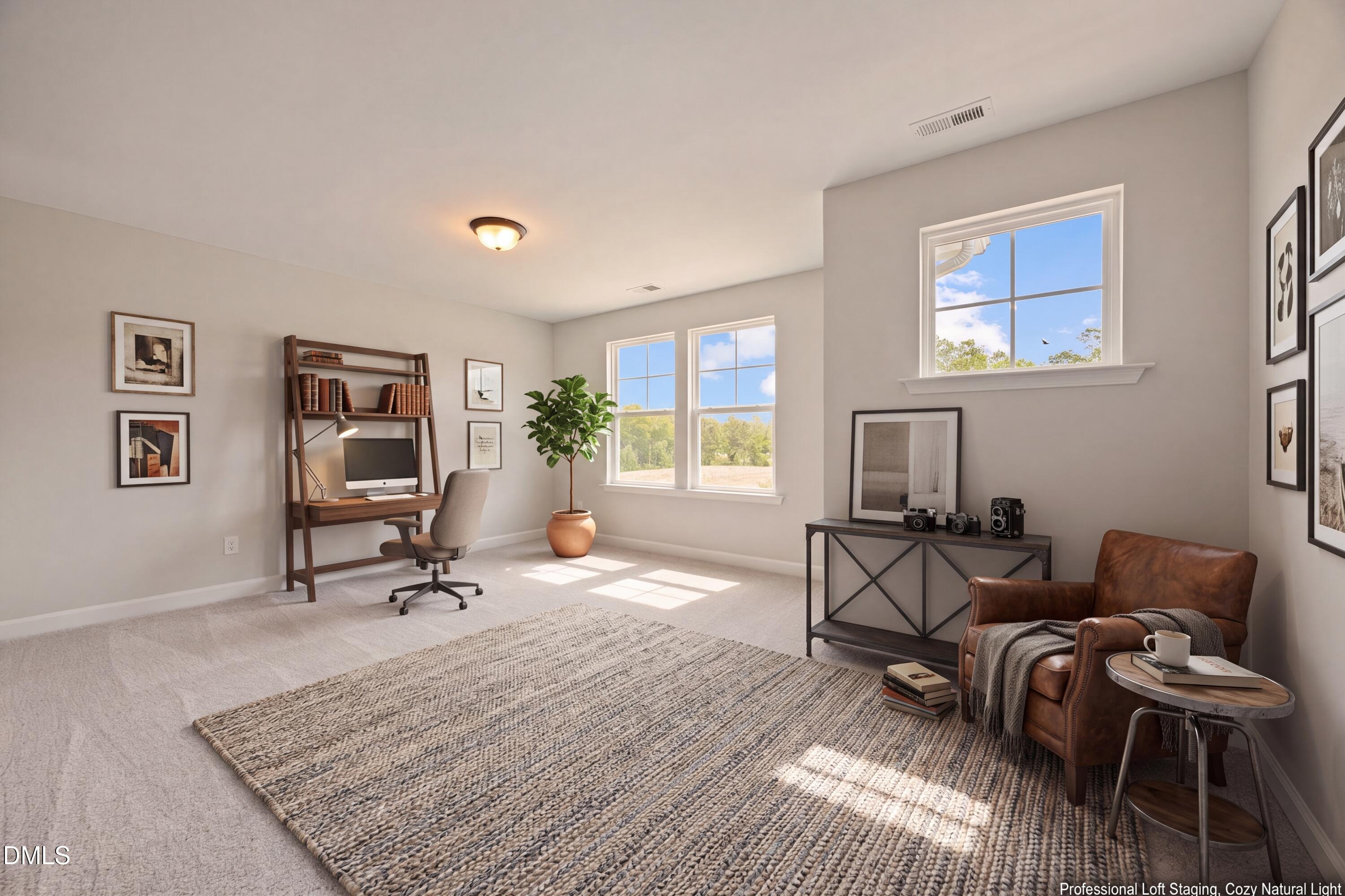 Bright home office with desk, leather armchair, and natural light in The Willow D floor plan at Wendell Ridge, NC.