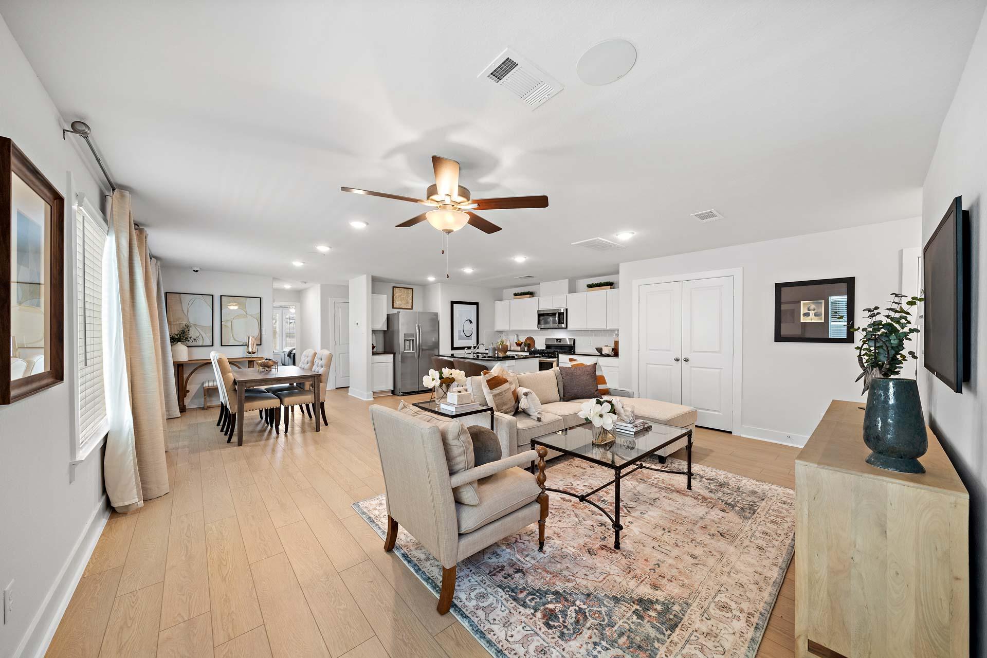 Spacious open-concept living and kitchen at Haven at Kieth Harrow in Cypress Texas with hardwood floors and neutral decor