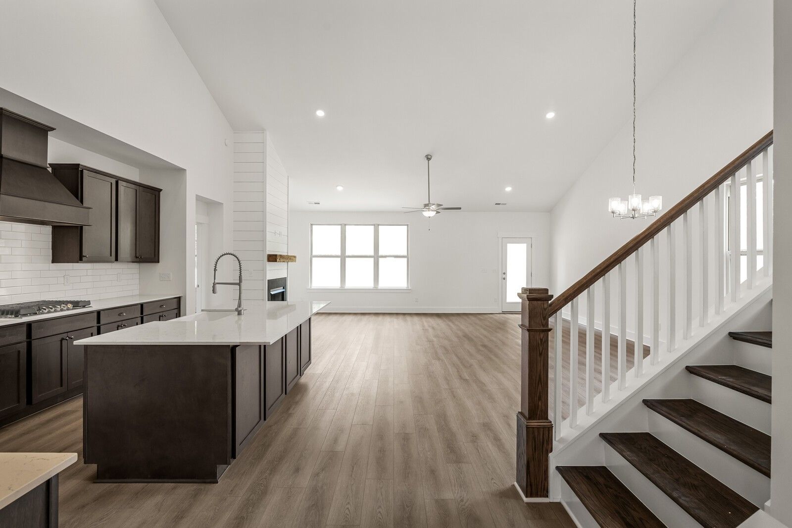 Open-concept kitchen and living area with vaulted ceilings in The Ridgeport C floor plan at Woods Crossing, Gallatin, TN.