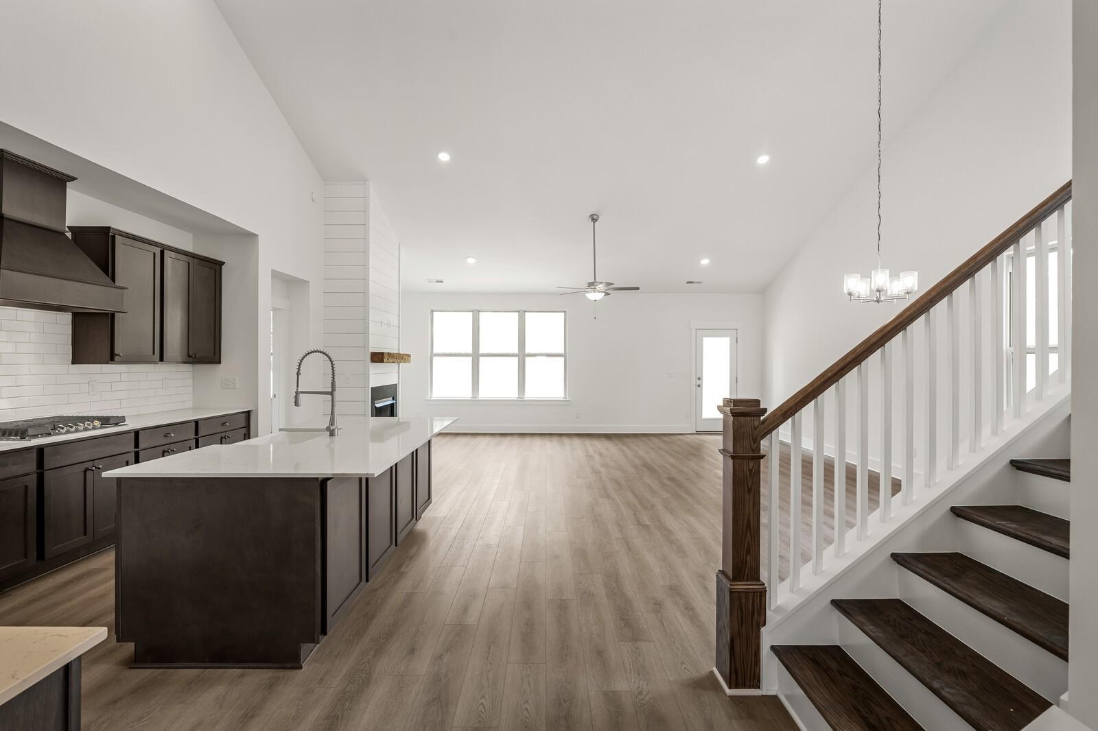 Open-concept kitchen and living area with vaulted ceilings in The Ridgeport C floor plan at Woods Crossing, Gallatin, TN.
